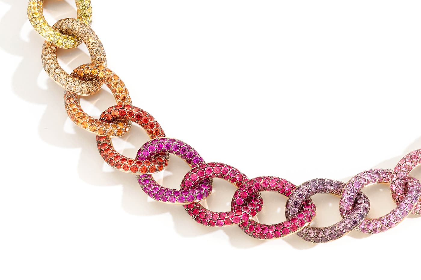 Pomellato's Gourmette Caméléon necklace features 29 gold links set with graduated multi-coloured gemstones