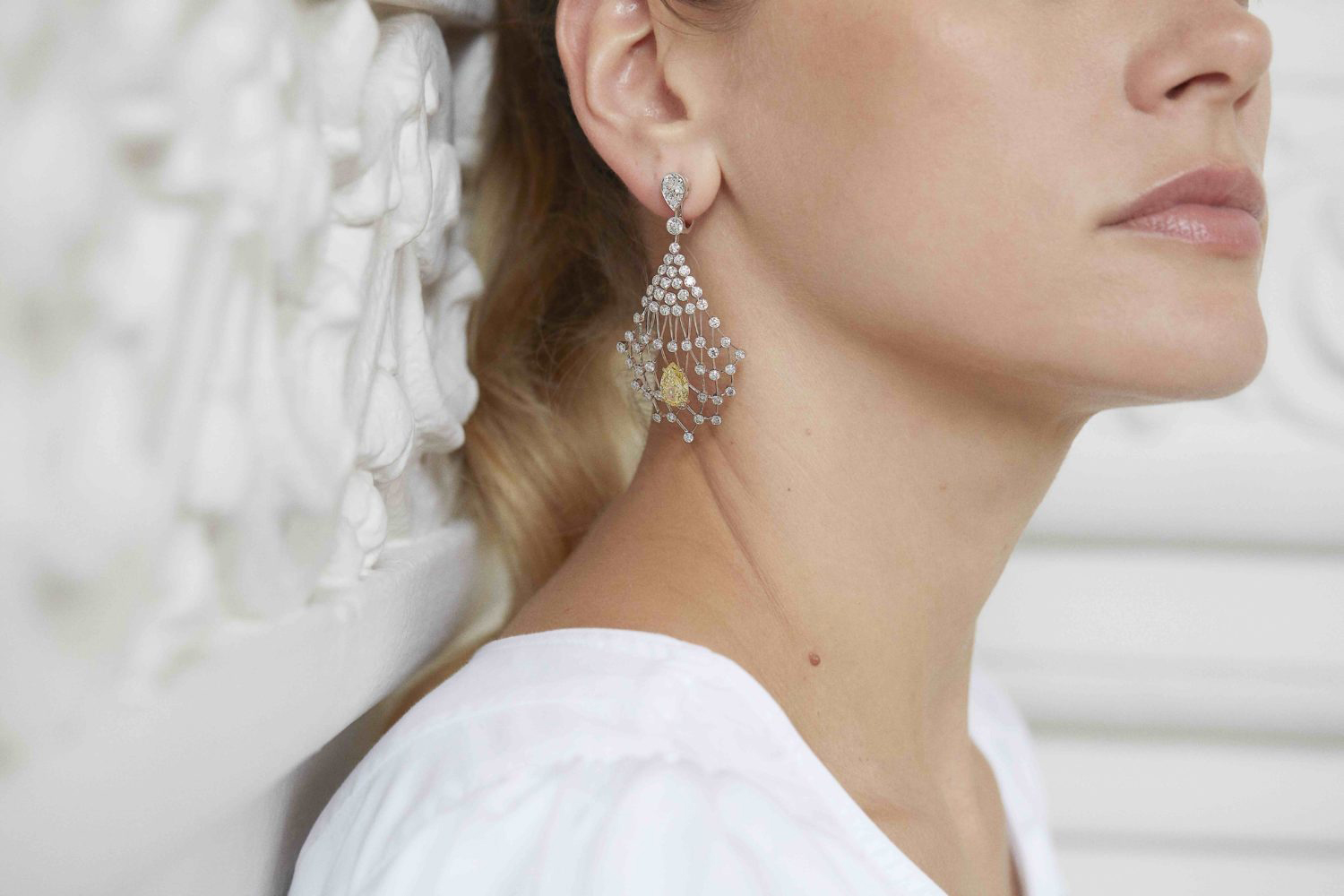  Expertly spun in white gold, these Lacis earrings are lit up by beautiful yellow diamonds