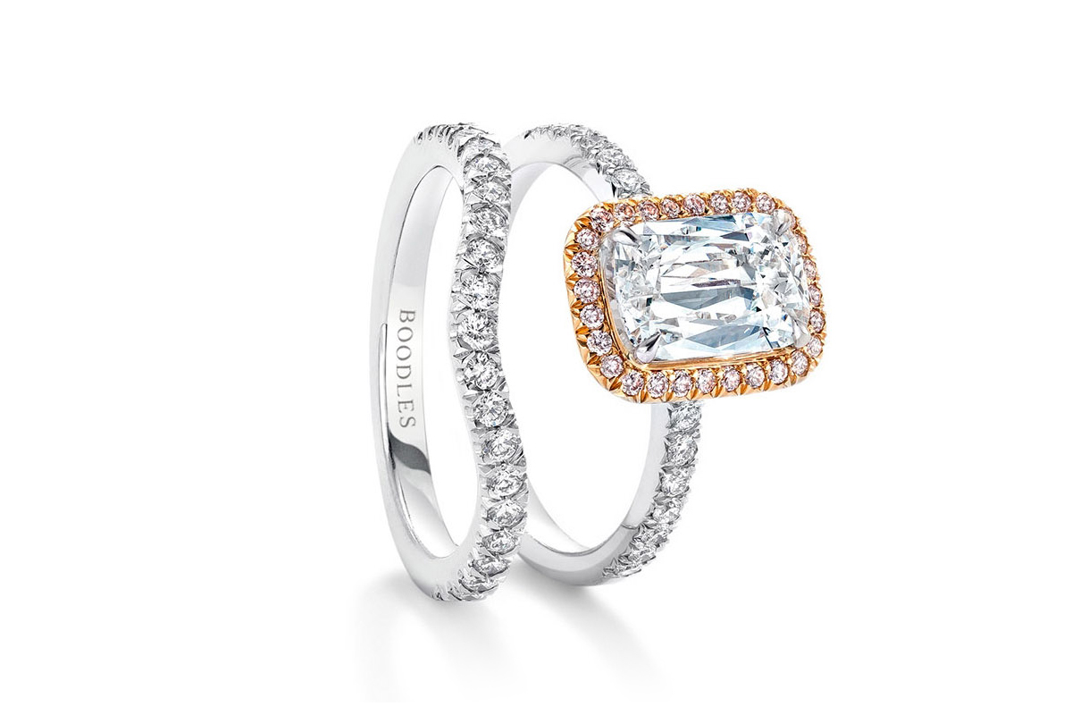 Boodles Vintage Ashoka diamond engagement ring with a pink diamond halo and shaped half-set diamond wedding band
