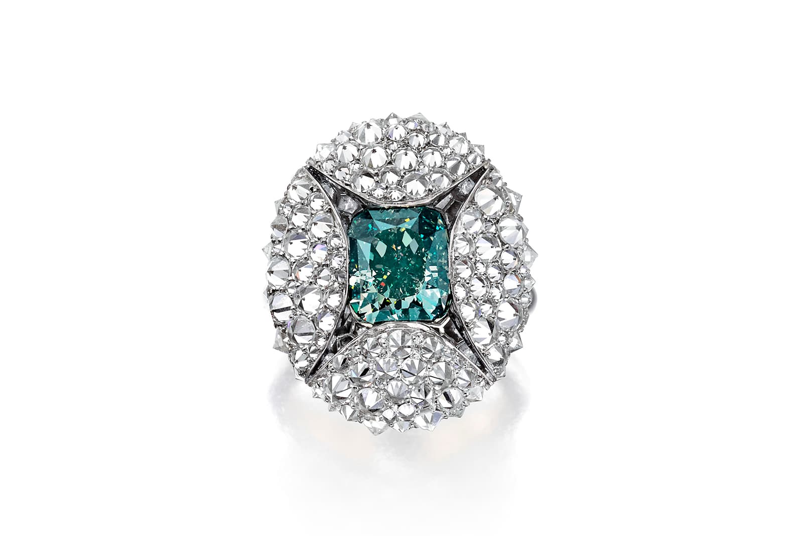  The ring features a 4.40 carat Fancy Deep Bluish-Green cushion-cut diamond that peeps out from a cocoon of reverse-set pavé diamonds in platinum