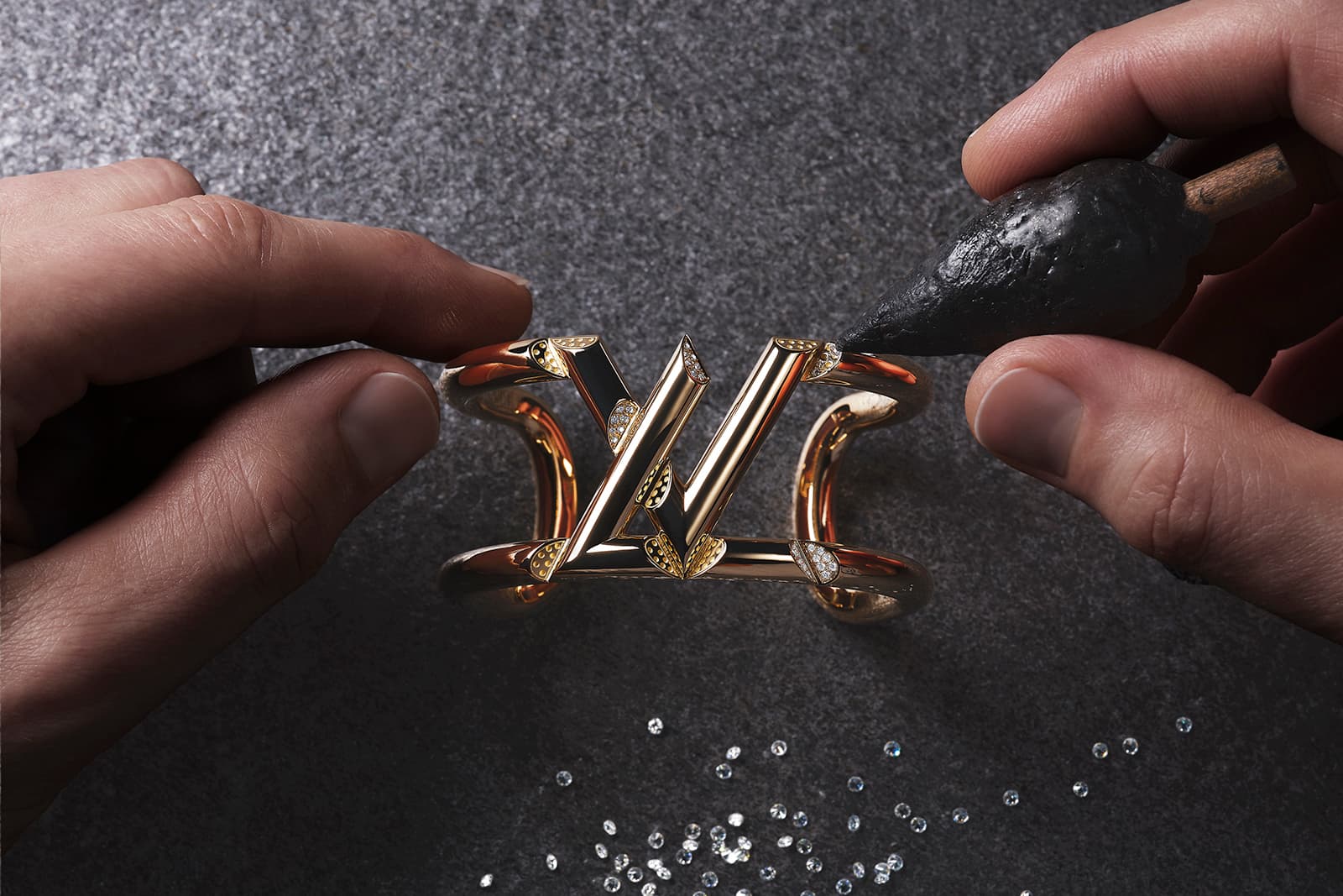 Louis Vuitton's diamond setters individually position stones on an LV Volt bracelet
