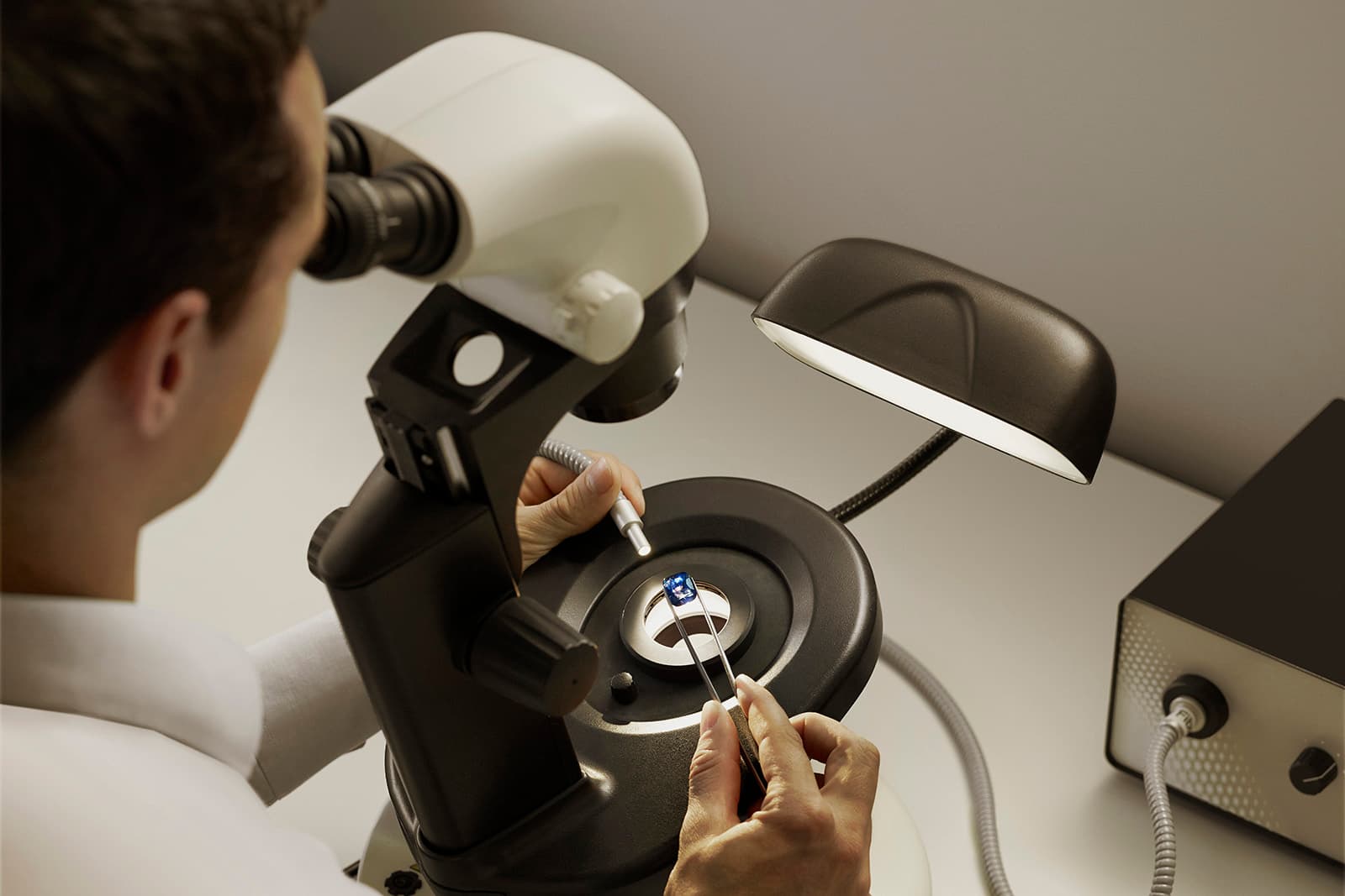 A sapphire is examined beneath a microscope at the Gübelin Gem Lab