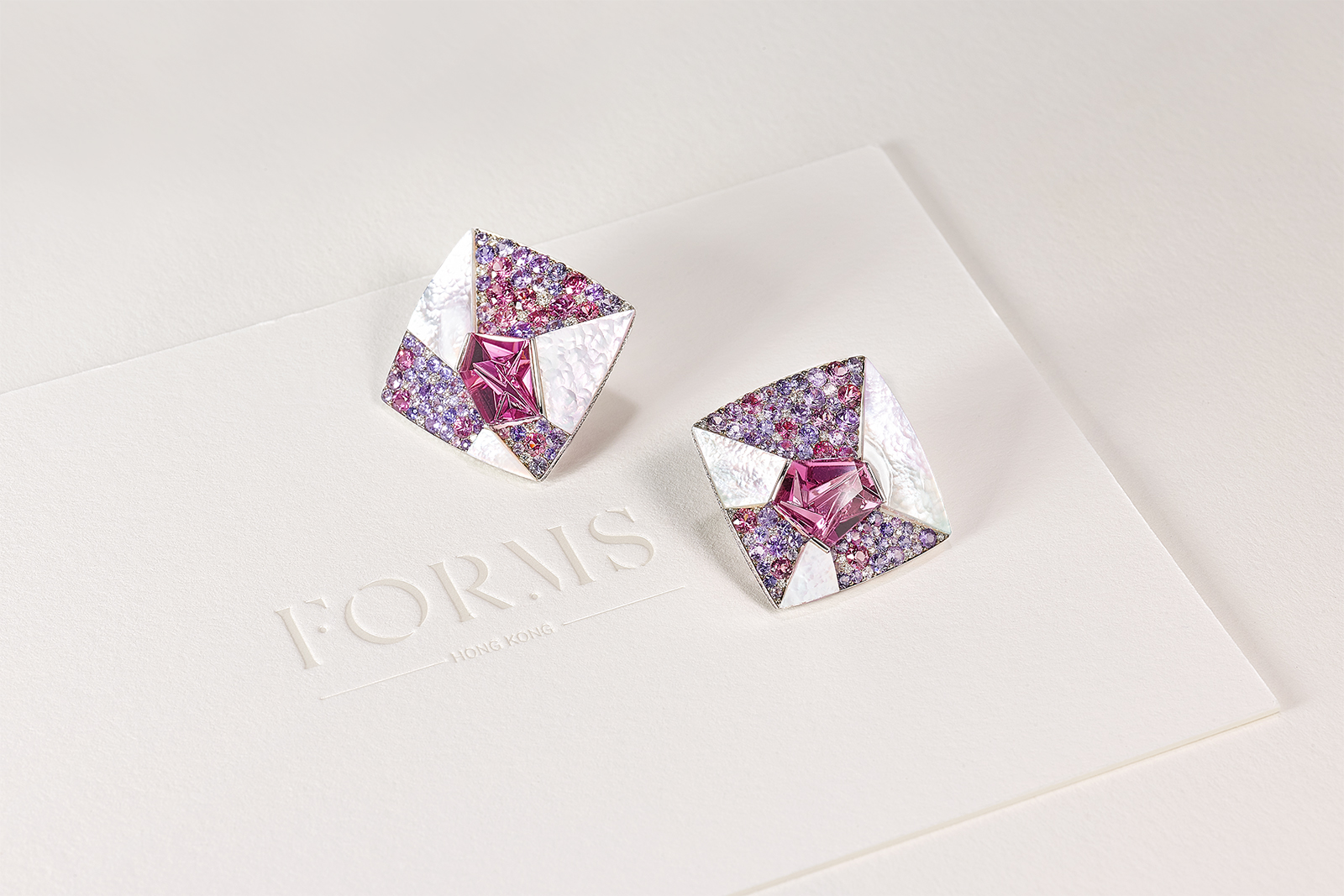 Canvas earrings featuring custom-cut fuchsia tourmalines at their heart