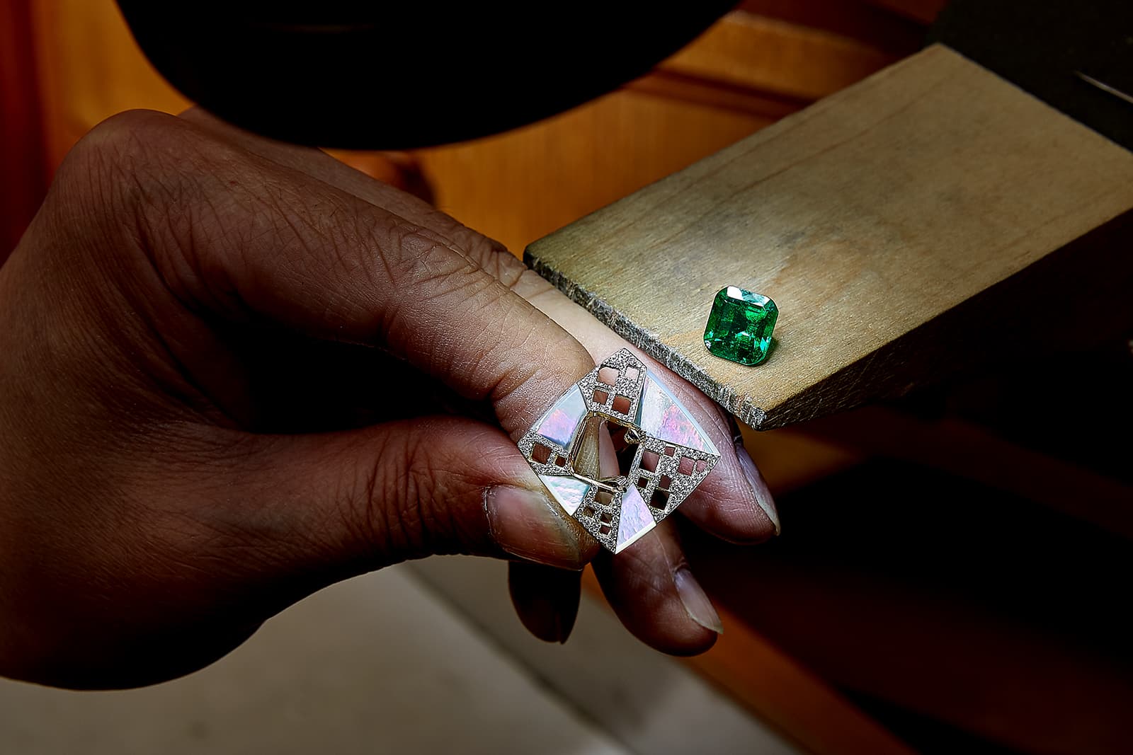 For one ring, slices of mother-of-pearl are set to form a geometric ray pattern