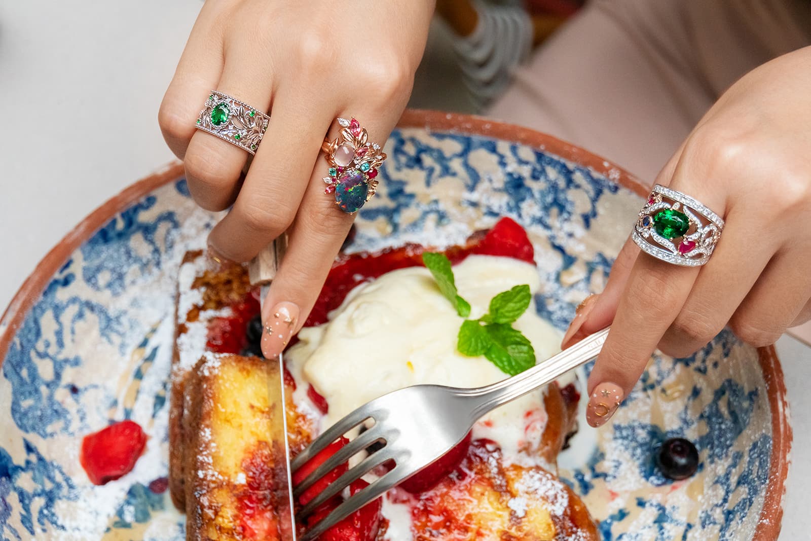 Left to right, Madly tsavorite filigree ring with twisting vines; opal and moonstone ring with pink spinels, sapphires, rubies, diamonds and Paraiba accents; and tsavorite ring with red spinels, rubies, blue sapphires and diamonds