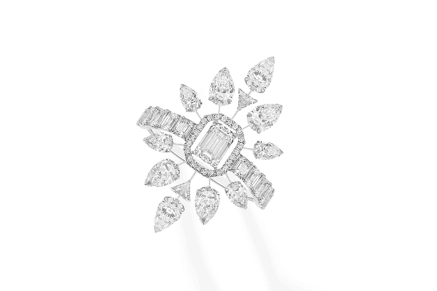  The suite also includes a strikingly symmetrical ring with a central emerald cut diamond