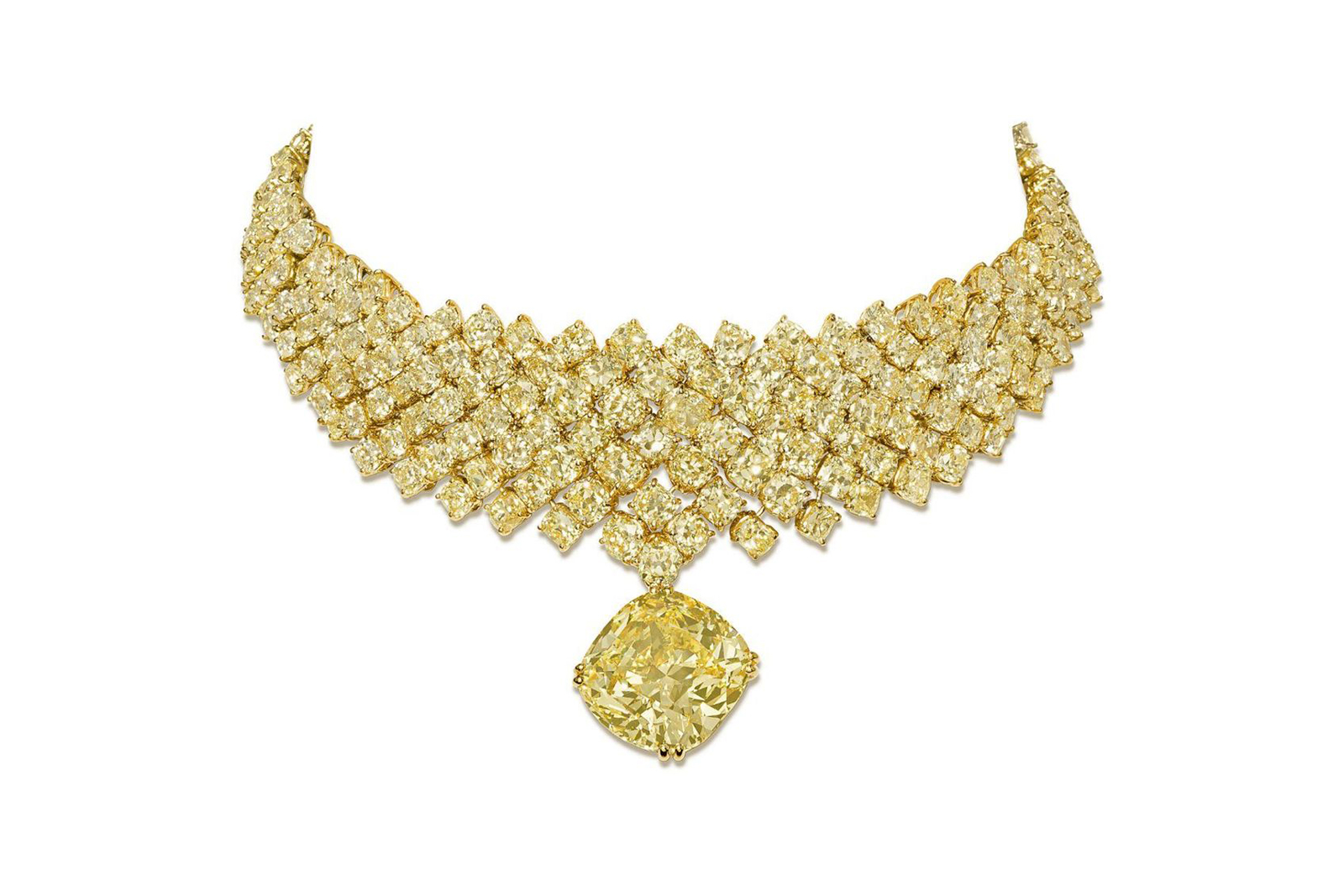  Suspended beneath is a jaw-dropping 26 carat cushion cut yellow diamond