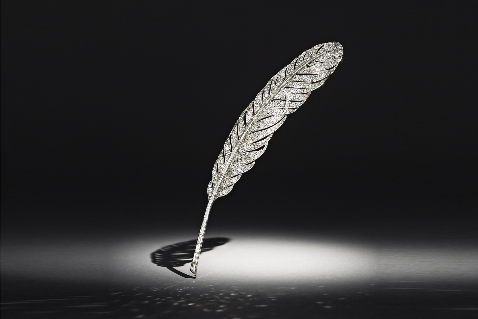  A platinum mounted diamond feather brooch by Van Cleef and Arpels, Paris, circa 1928, showcasing the Mystery Setting