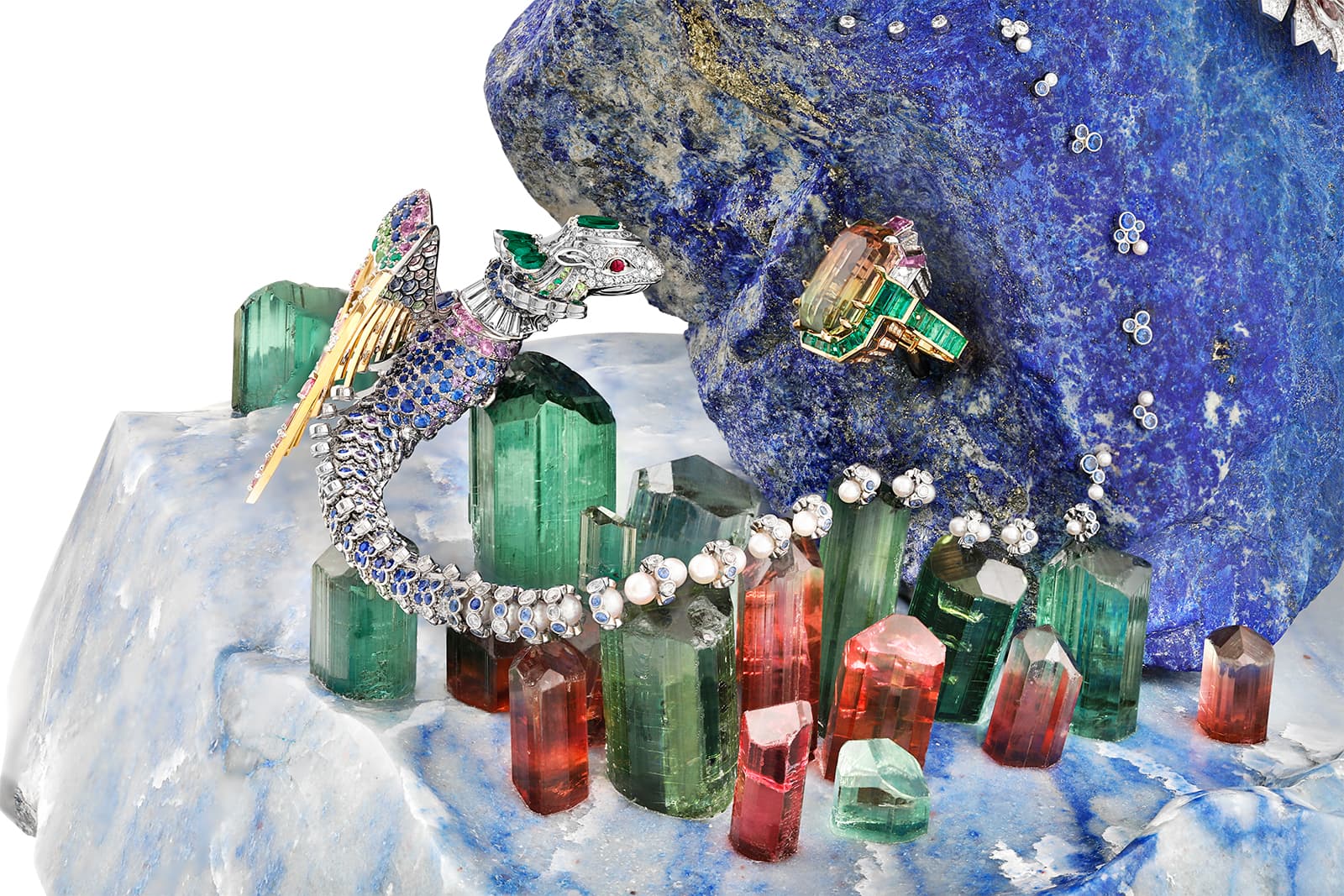  A 6.2kg steep mountain of lapis lazuli rises above a rugged base of blue quartz, accompanied by a forest of 32 tourmaline crystals 