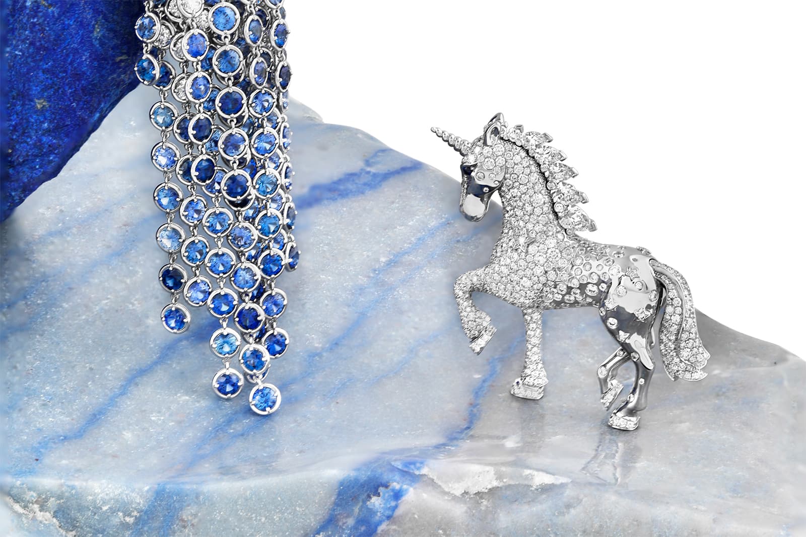  A unicorn rests beside a waterfall of diamonds and sapphires. Part of the miniature sculpture is removable, which enables it to be worn as a brooch