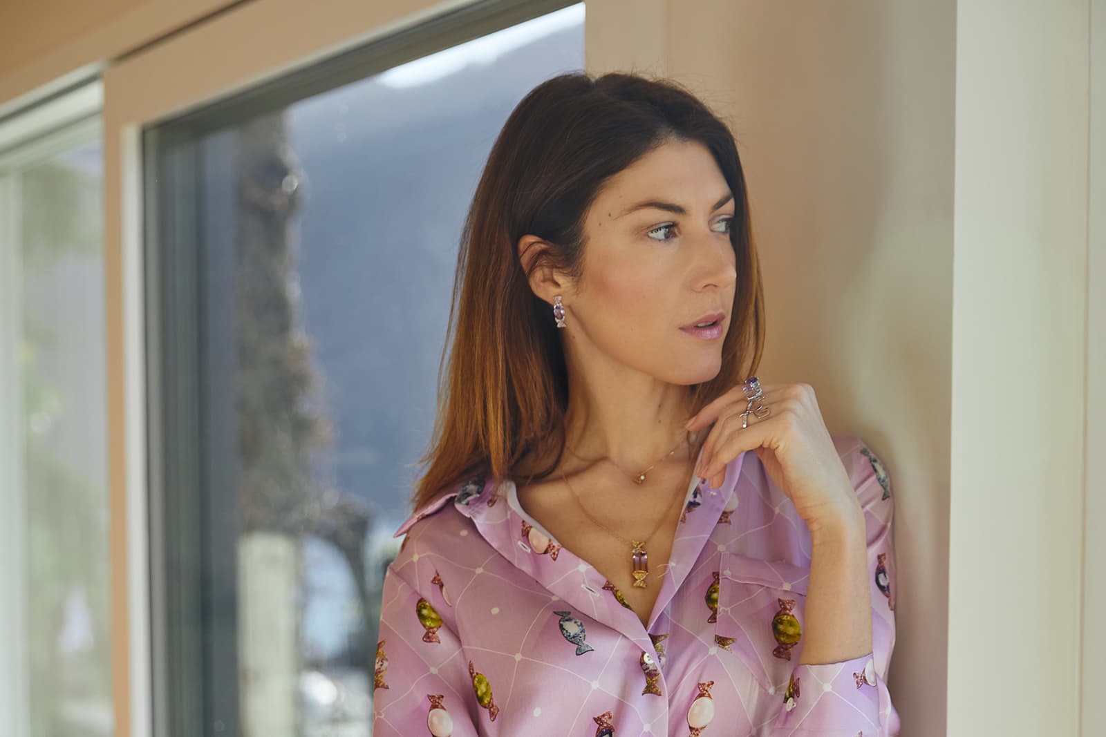  Vanessa wears her playful Caramella jewels alongside the silk shirt in pink