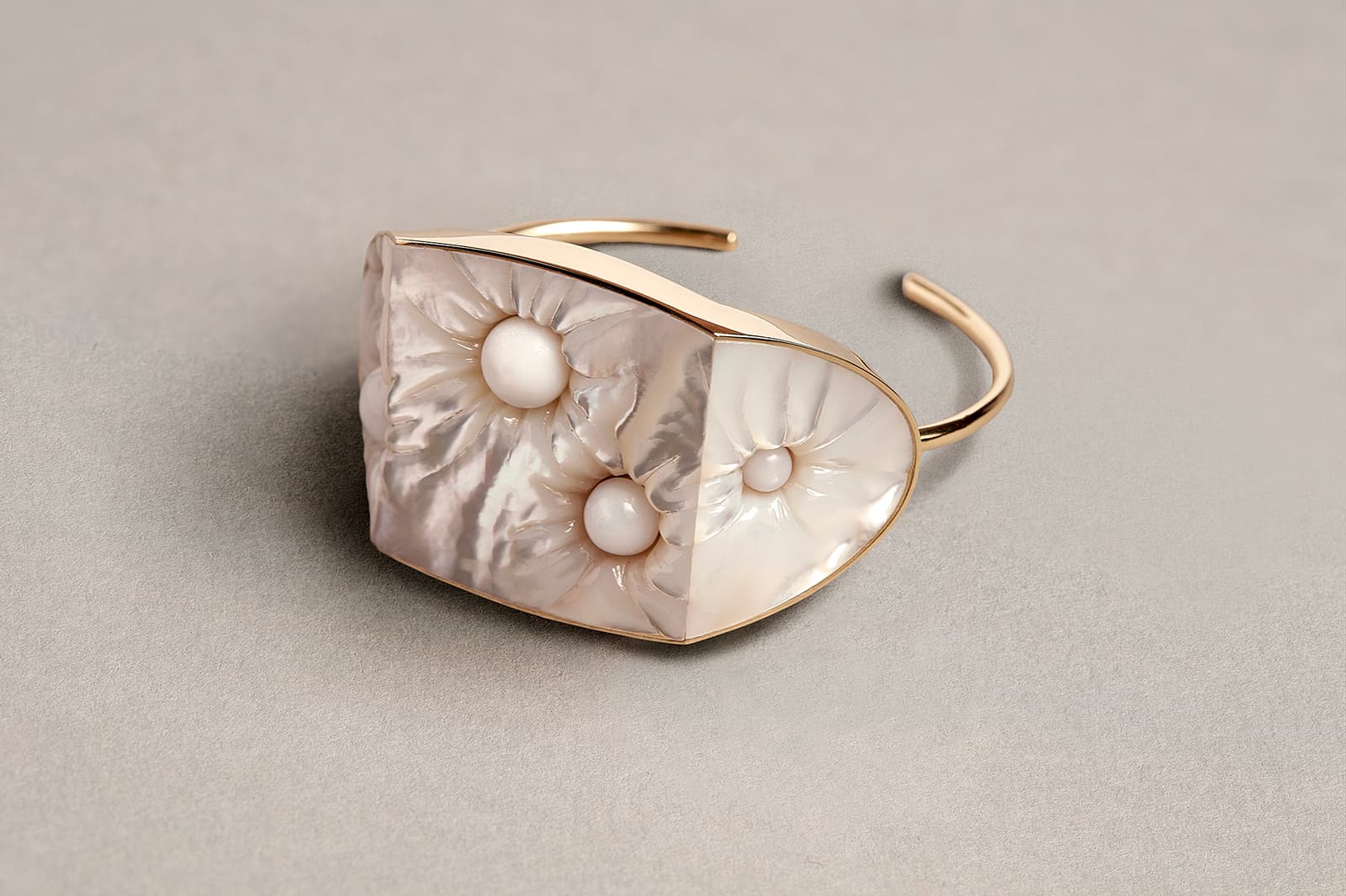 Melanie Georgacopoulos Pearl Embedded Bangle from the Carats Collection with mother of pearl and hippopus pearls in 18ct yellow gold