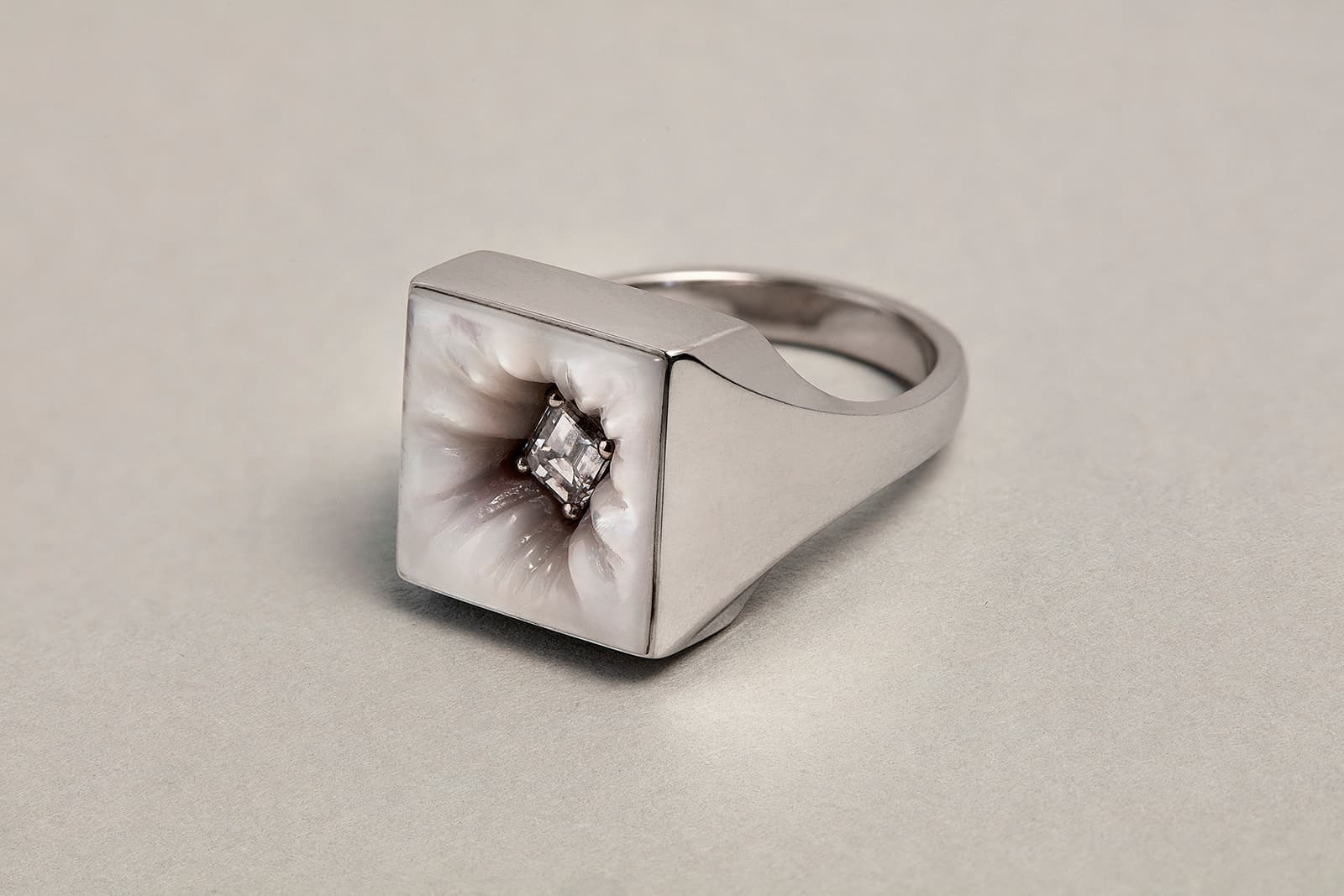  Melanie Georgacopoulos Sqaure Embedded Ring from the Carats Collection with mother of pearl and an emerald cut diamond in 18ct white gold