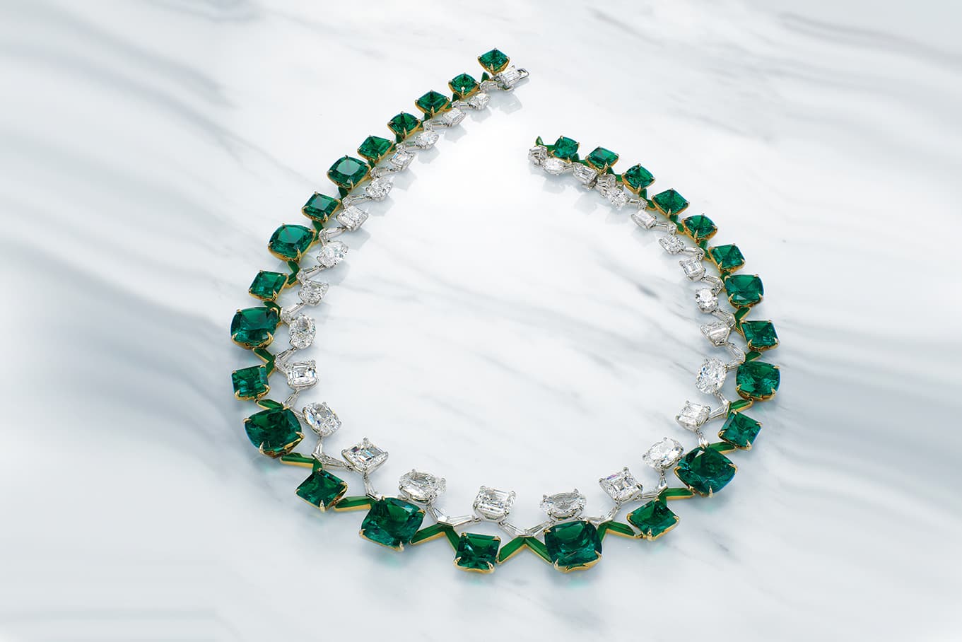 Twenty-eight cushion and octagonal-cut emeralds of 10.41 to 1.48 carats, twenty-two oval and rectangular-cut diamonds of 4.22 to 0.70 carats, vari-cut diamonds, fancy-cut jadeite, gold, inner circumference 40.0 cm, signed Boghossian, designed by Edmond Chin, white Boghossian case