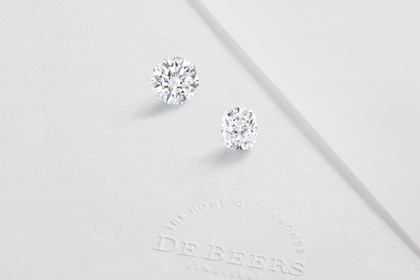 Two diamonds - a round brilliant and a pear-shape - in the De Beers 1888 Master Diamonds Collection cut from an original rough stone of 40.91 carats