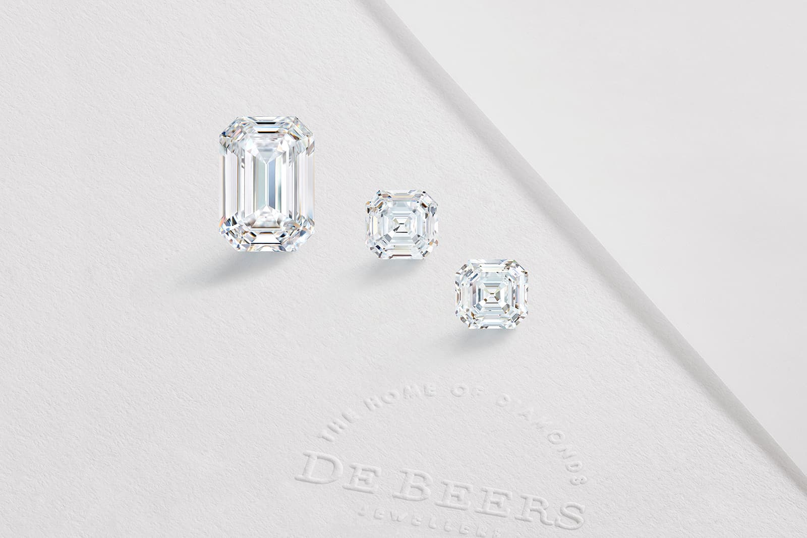  Three diamonds, including a 26 carat emerald-cut, in the De Beers 1888 Master Diamonds Collection cut from an original rough stone of 107.58 carats
