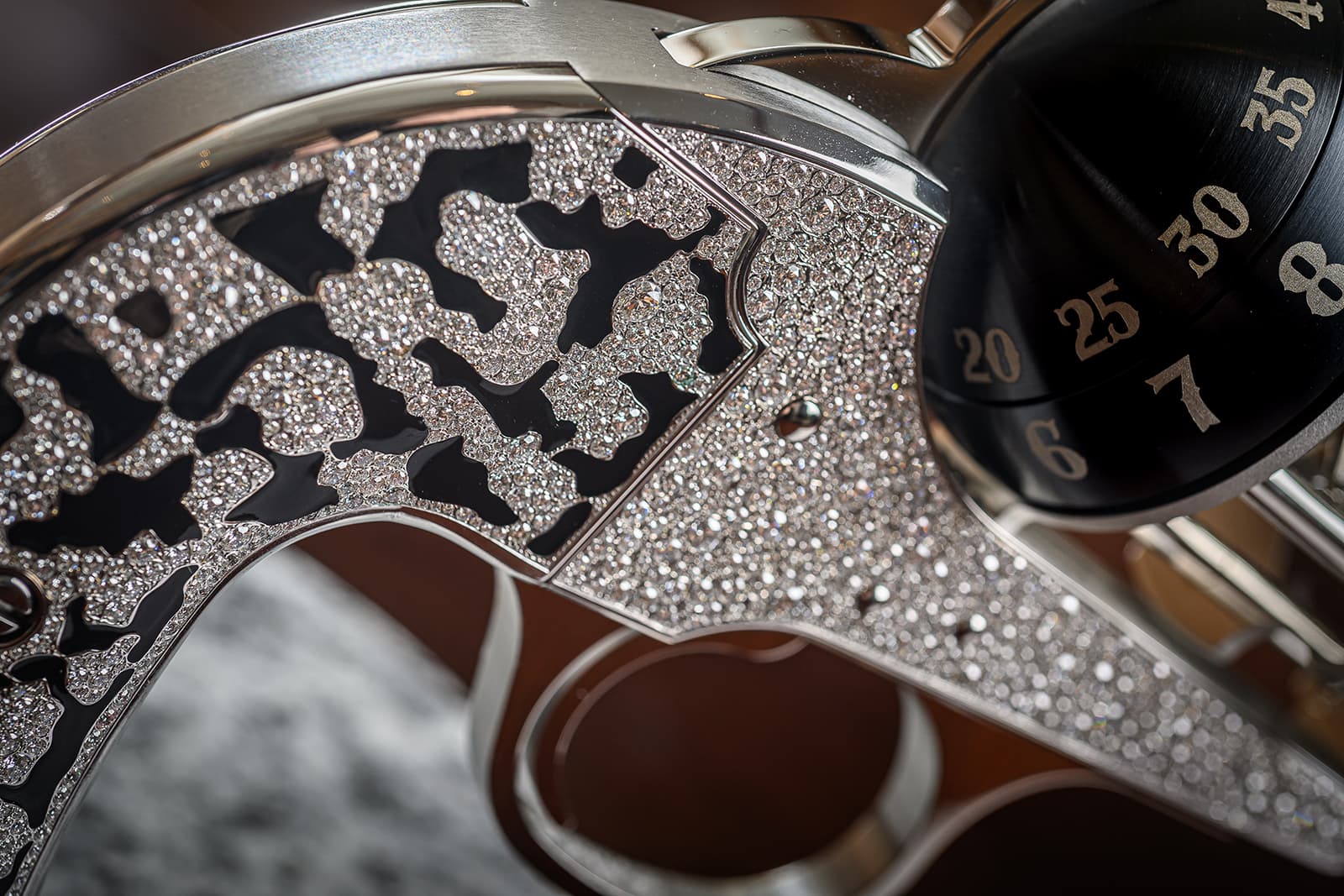 Close-up detail of the black lacquer and diamond grip of 'The Diamond' revolver table clock