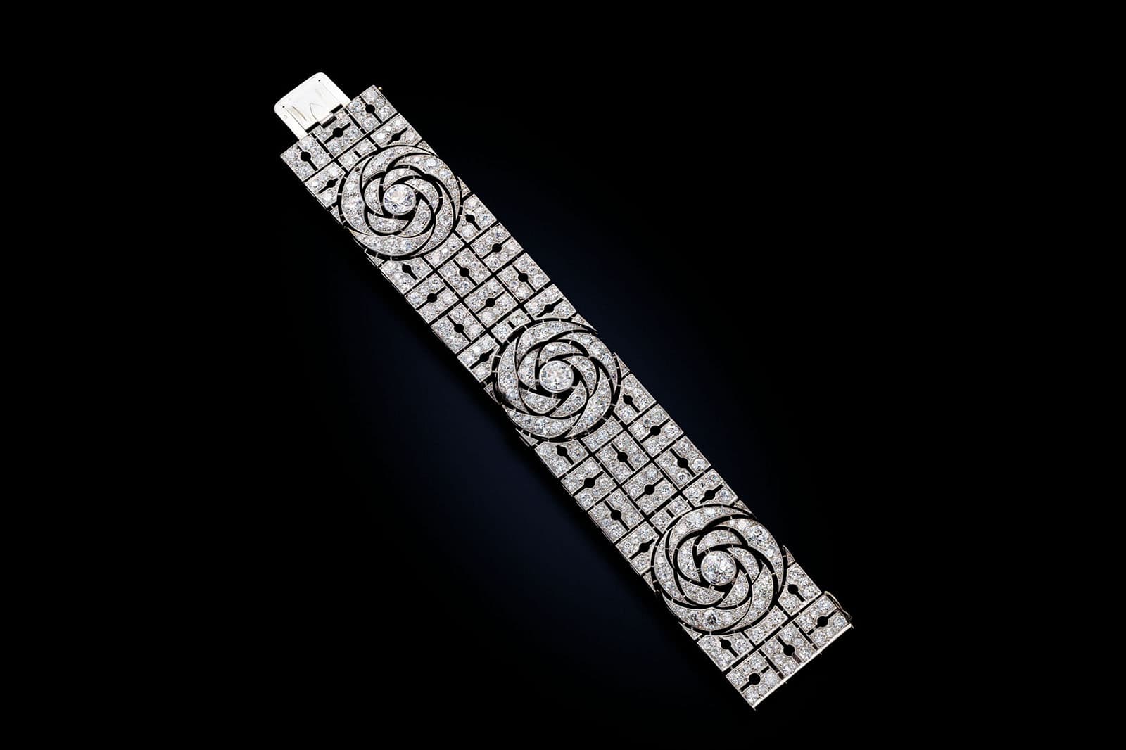  This Art Deco Boucheron diamond bracelet contains three swirling diamond motifs that wrap around the wrist