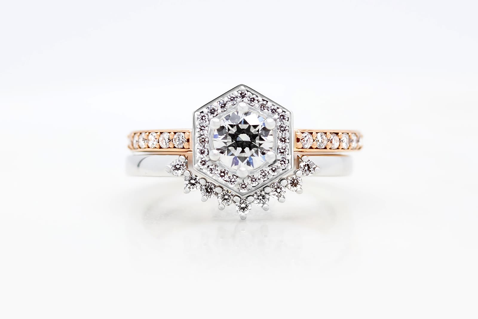  Taylor & Hart matching engagement and wedding ring set with a round diamond surrounded by a hexagonal diamond halo 