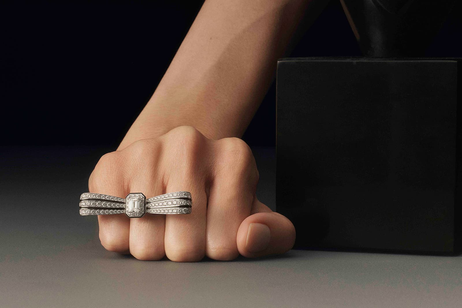 Boucheron Nœud Diamants bow tie ring with a 1.50 carat emerald-cut diamond, further diamonds and black lacquer in white gold from the ‘A History of Style, Art Déco’ High Jewellery collection