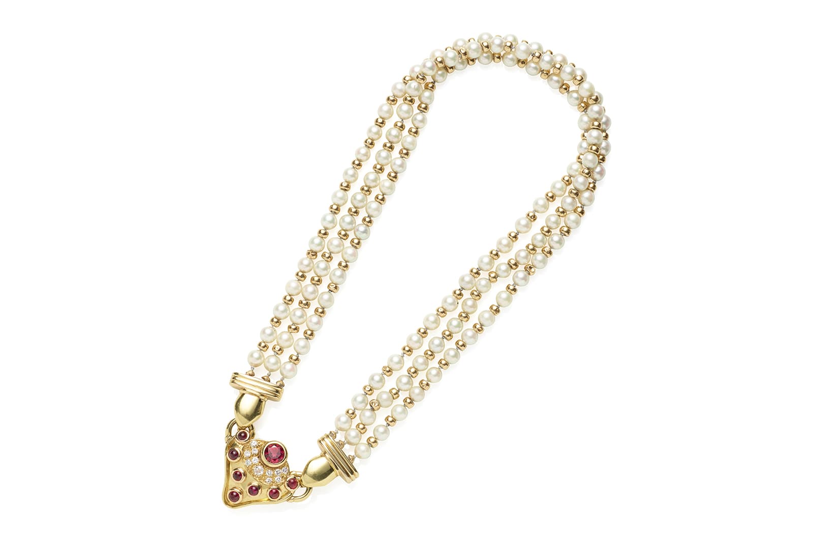  A multi-strand white pearl necklace with a red tourmaline cabochon and diamonds in gold, auctioned by Bonhams