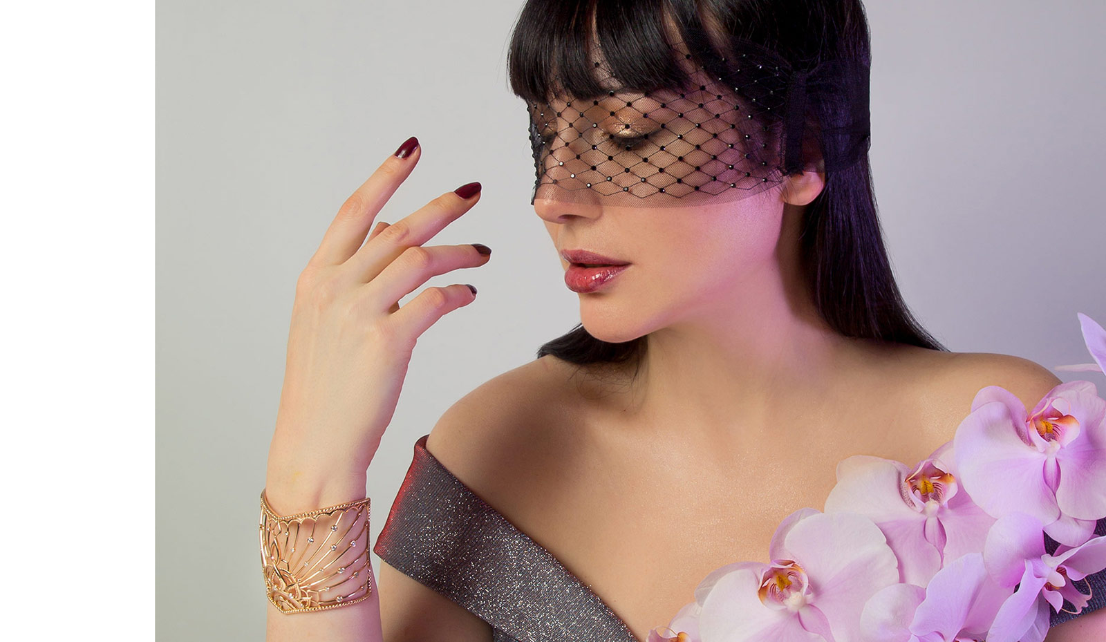 Katerina wears a dress by Promulias, a mask by Maison Close and the Grand Soir cuff by Maison Veyret