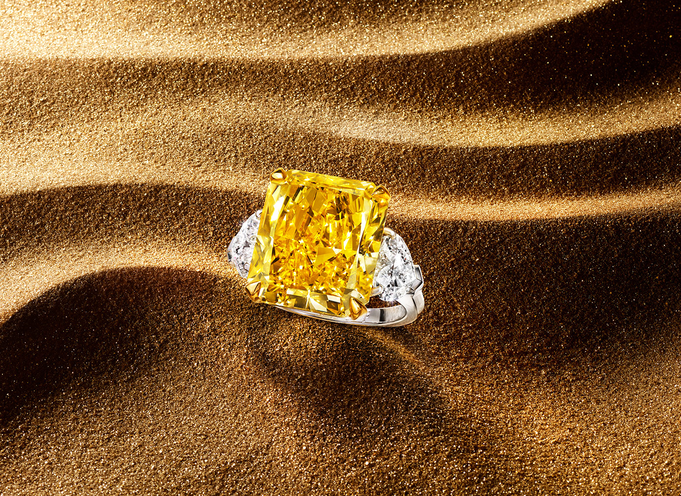  A yellow diamond ring flanked by two colourless diamond side stones from the Graff Tribal High Jewellery Collection