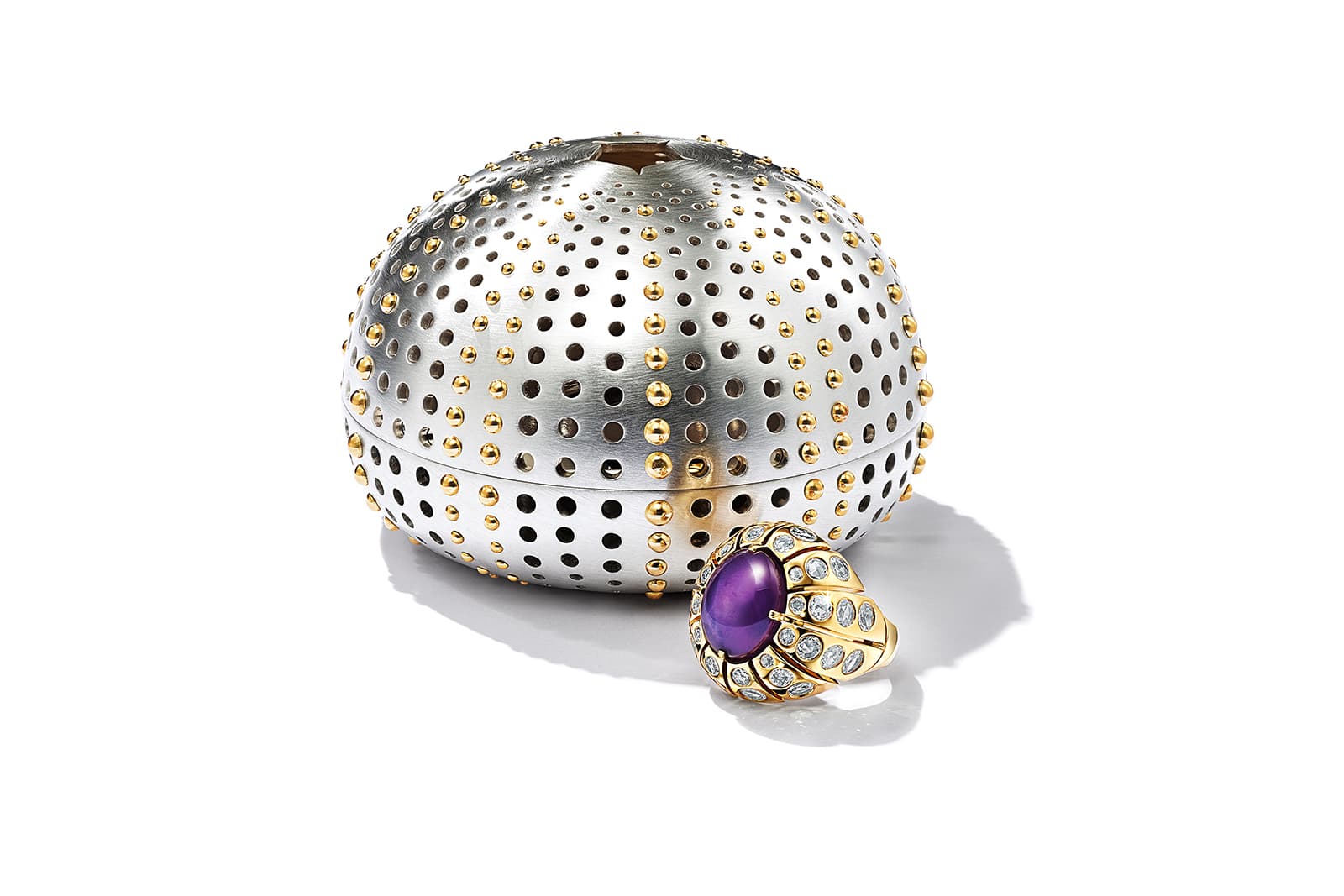 Tiffany & Co. Sea Urchin ring with a 12 carat unenhanced purple star sapphire surrounded by rose-cut diamonds alongside a sterling silver and 18k yellow gold case from the Colors of Nature High Jewellery Collection