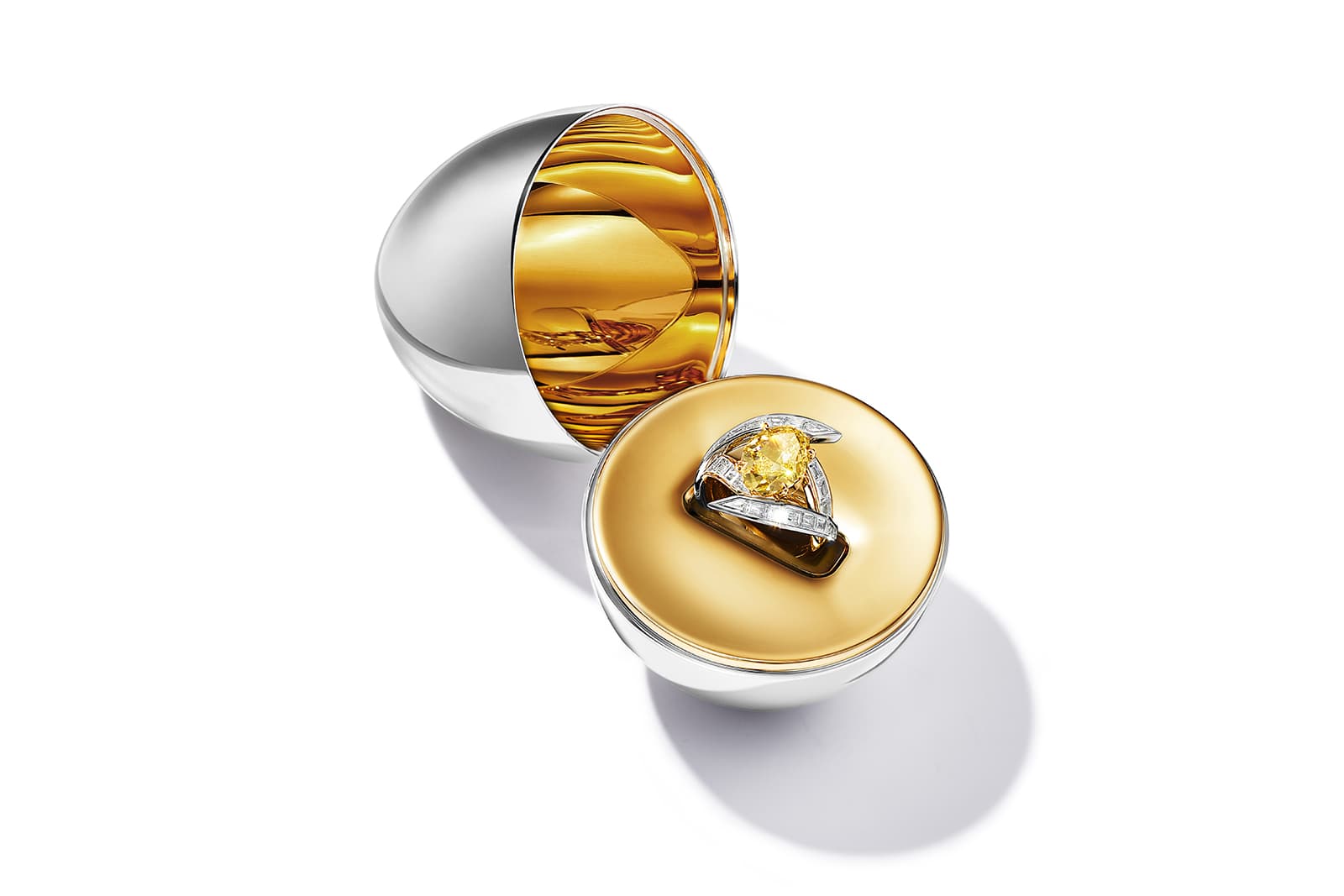  Tiffany & Co. Sky ring with an oval-shaped modified brilliant-cut fancy vivid yellow diamond of over 5 carats and baguette diamonds with an egg-shaped vessel in sterling silver and 18k yellow gold, part of the Colors of Nature High Jewellery Collection