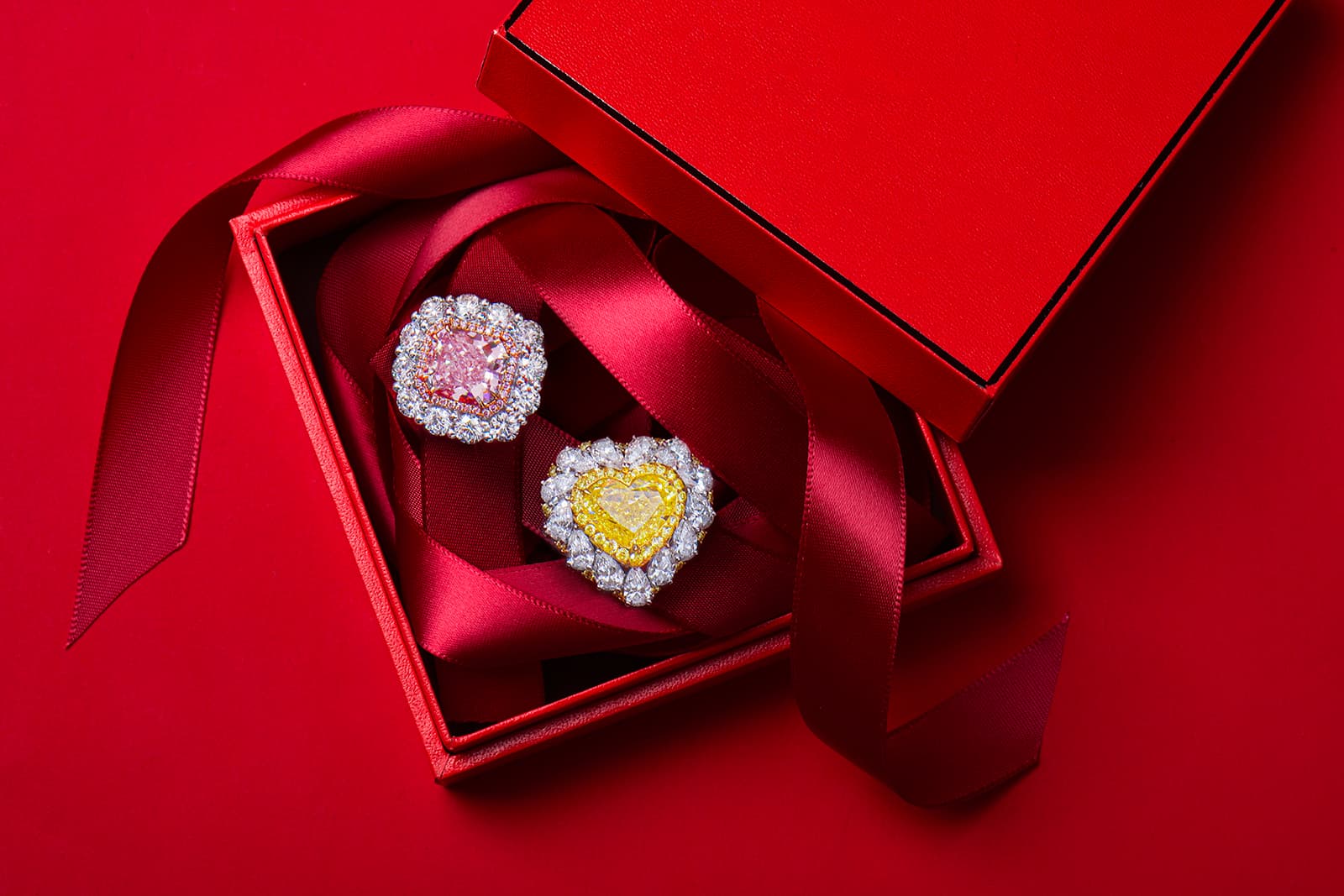  Astteria ring with a 4.20 carat pink diamond surrounded by pink and white diamonds, and a 5 carat vivid yellow diamond ring with a further 4 carats of pear-shaped diamonds