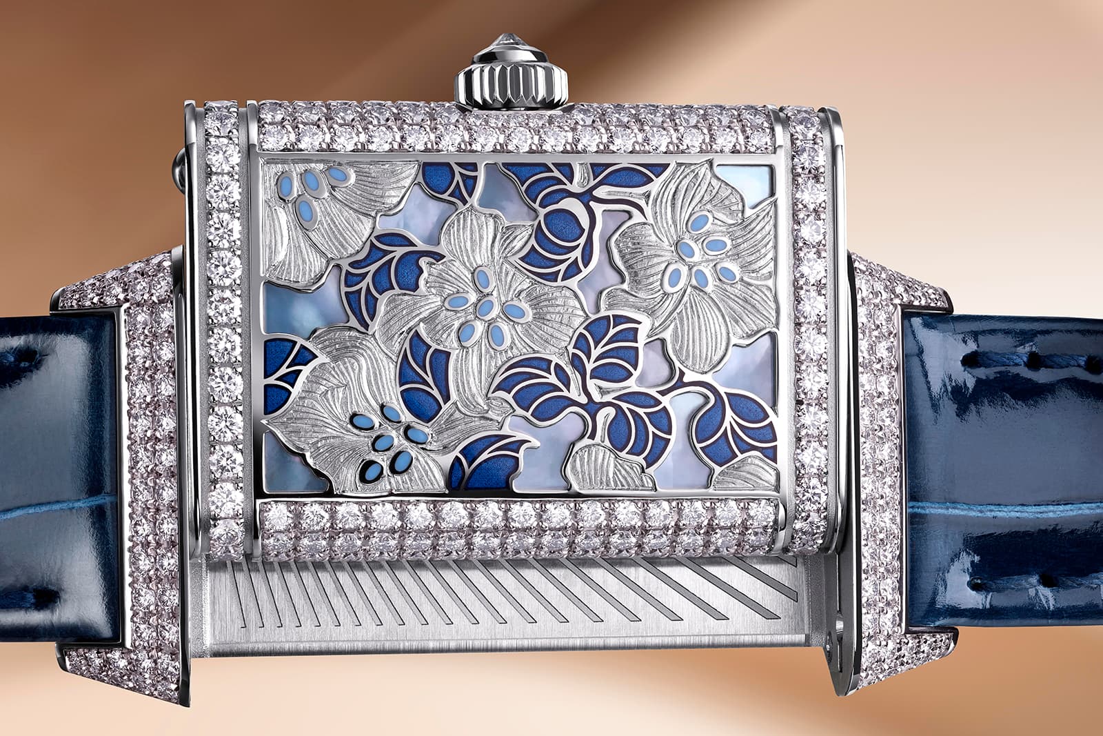  The case back of the Jaeger LeCoultre Reverso One Precious Flowers White Lilies watch with 335 diamonds, engraved flowers and enamelled leaves on mother of pearl