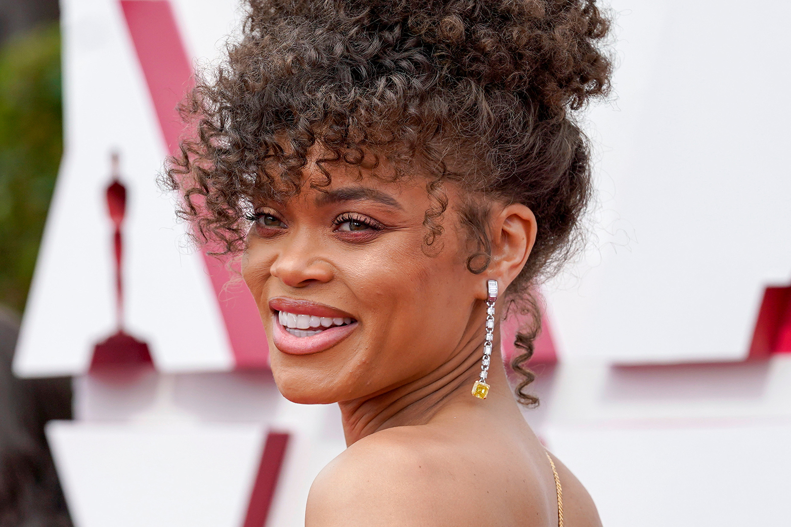 Actress Andra Day on the 2021 Oscars red carpet wearing a pair of Tiffany & Co. earrings with two square emerald-cut fancy vivid yellow diamonds, totalling over 12 carats