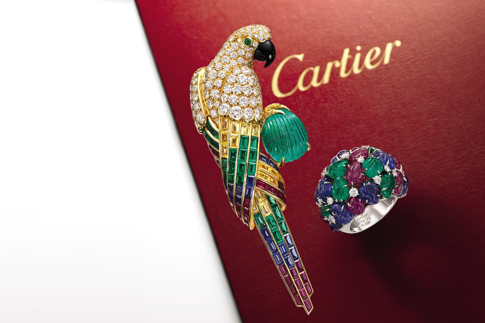 Cartier Tutti Frutti inspired parrot brooch and carved gemstone ring sold by Sotheby's