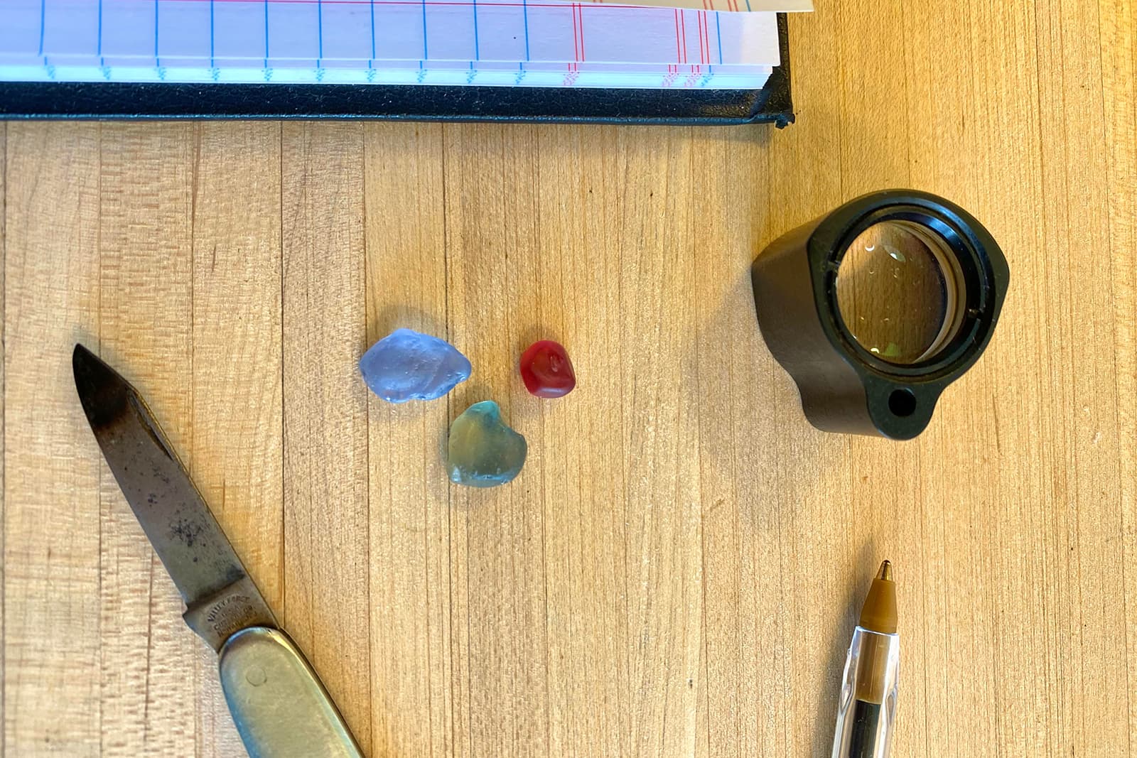  A small cluster of gemstones on the desk of Jean-Noel Soni of Top Notch Faceting 