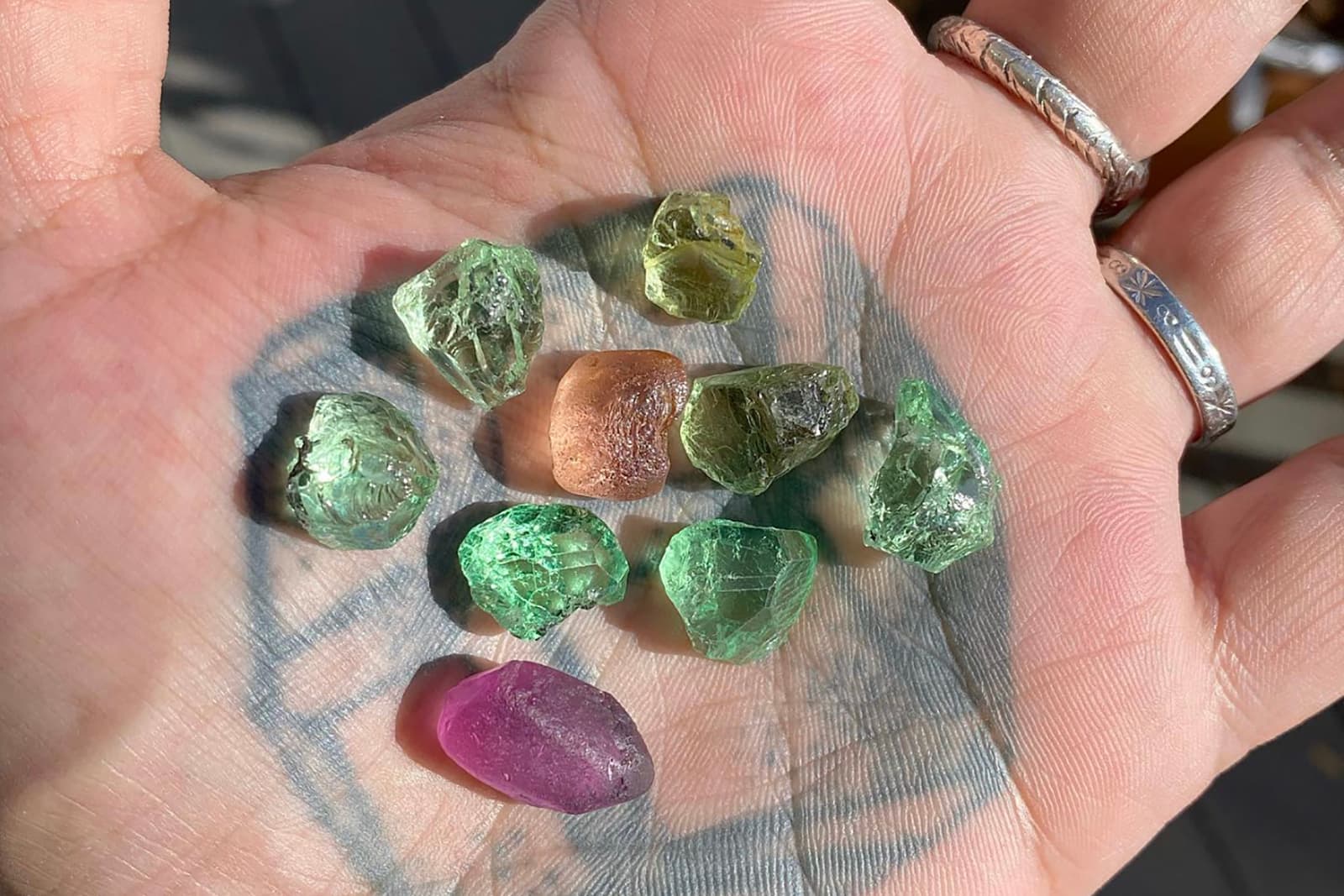  Gemstones at various stages of the cutting process in the hand of Jean-Noel Soni of Top Notch Faceting 
