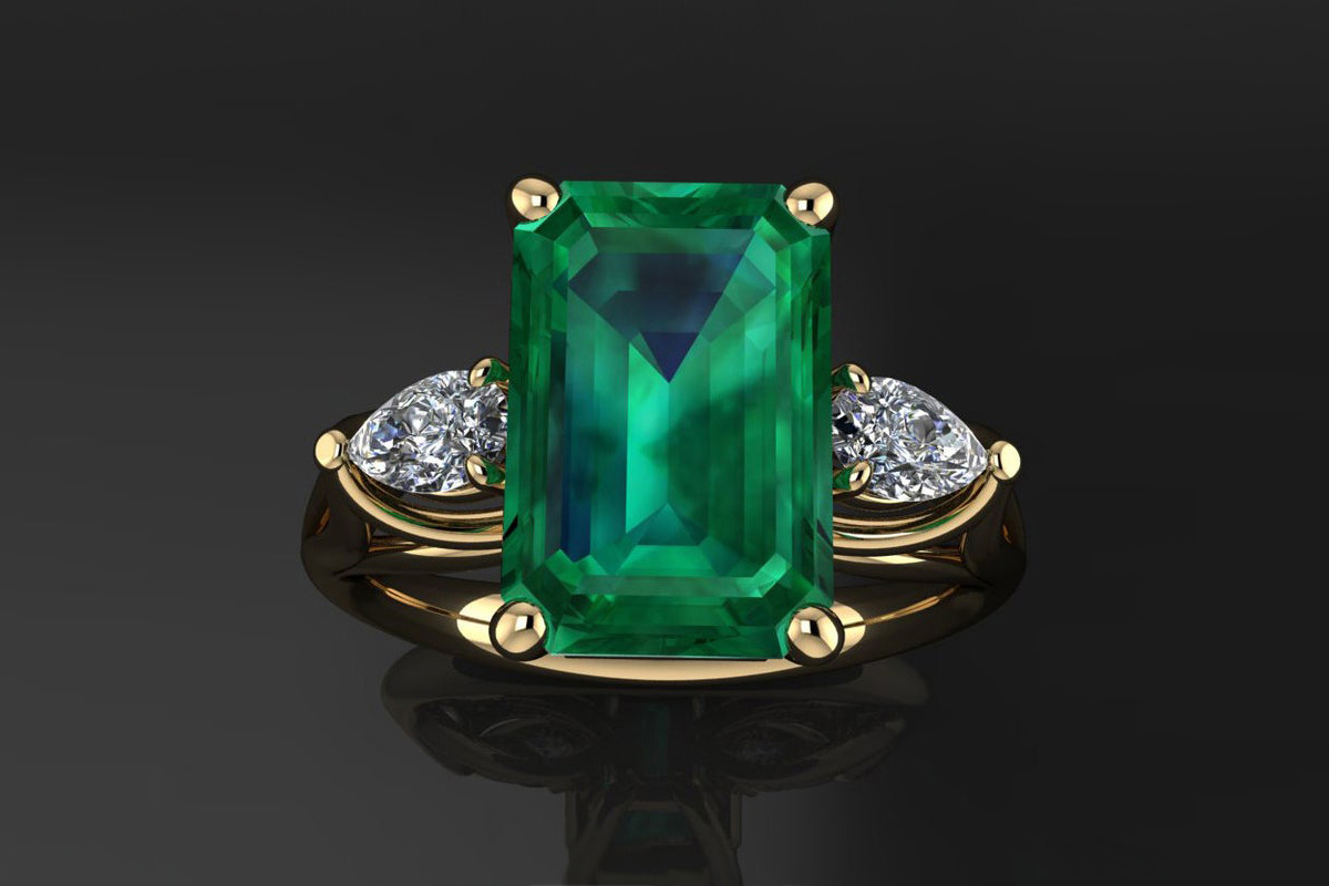  Actress Michelle Yeoh's emerald ring, set in yellow gold, with two pear-shaped accent diamonds