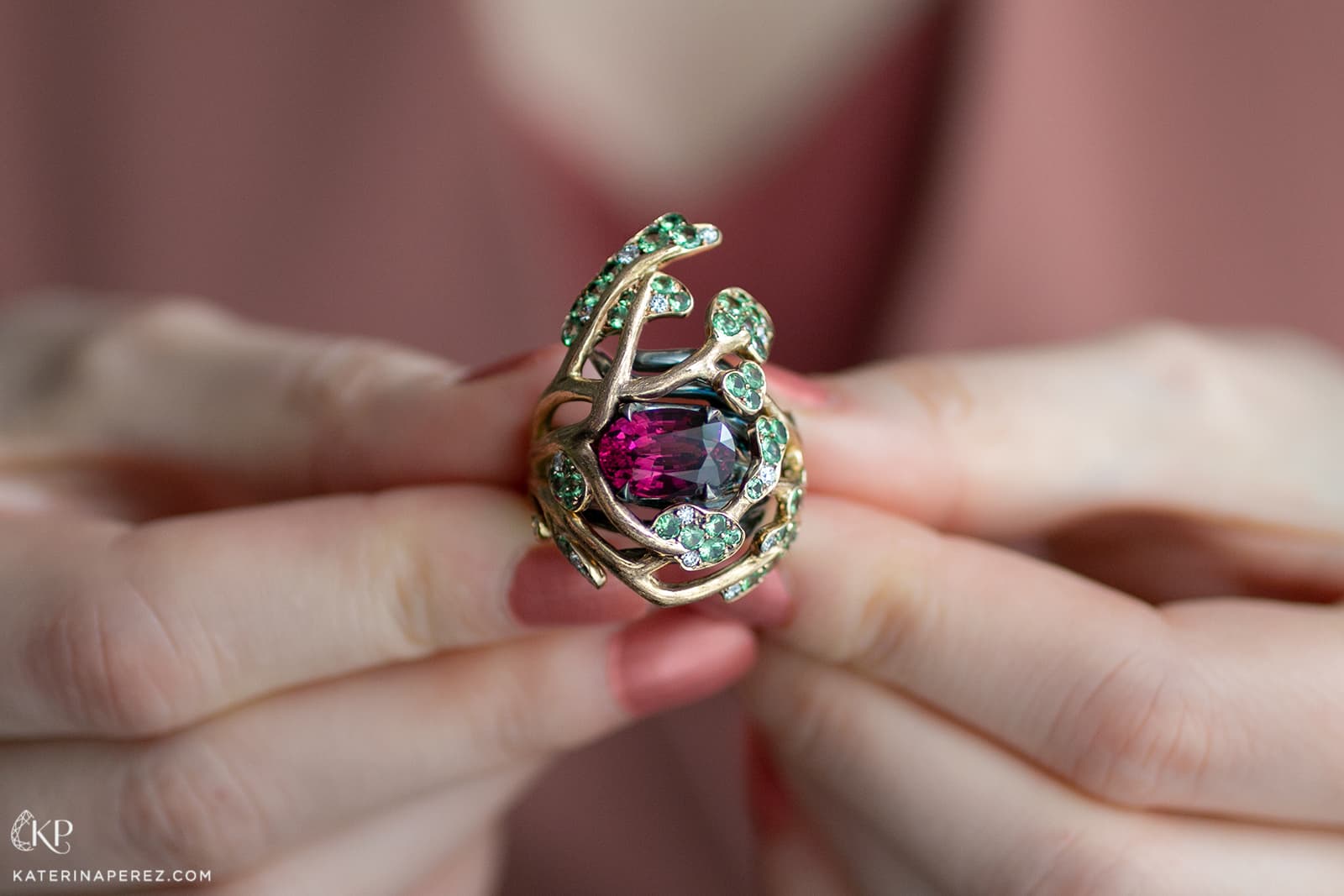 Maison Alix Dumas ring with a rhodolite garnet centre stone, surrounded by tsavorite garnets and diamonds and set in Fairmined gold and recycled silver