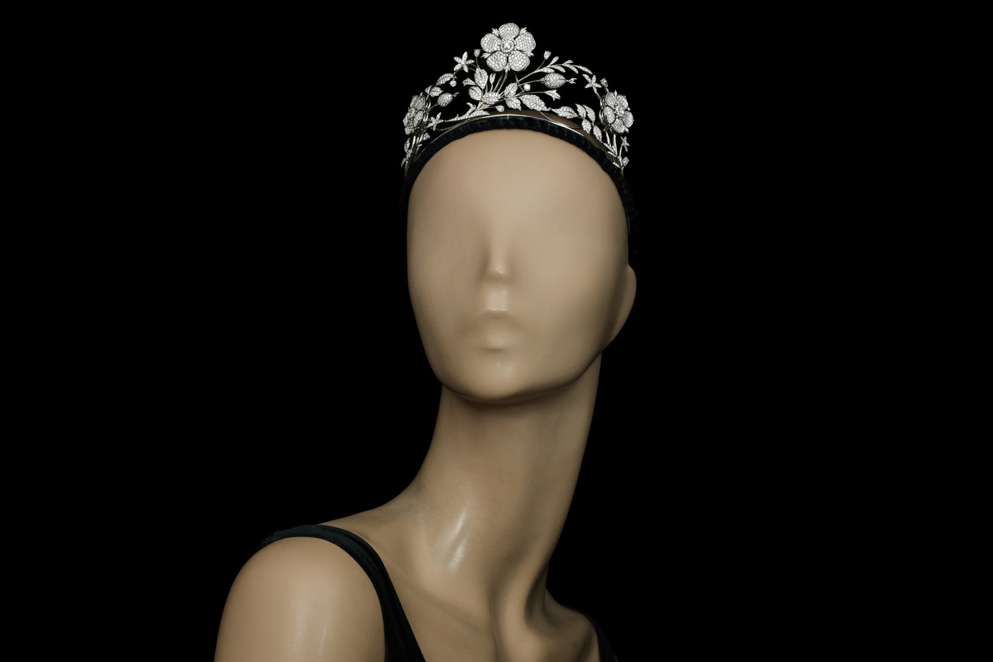  This floral tiara by E. Wolfe & Co. is of asymmetrical design and feature a velvet covered headband