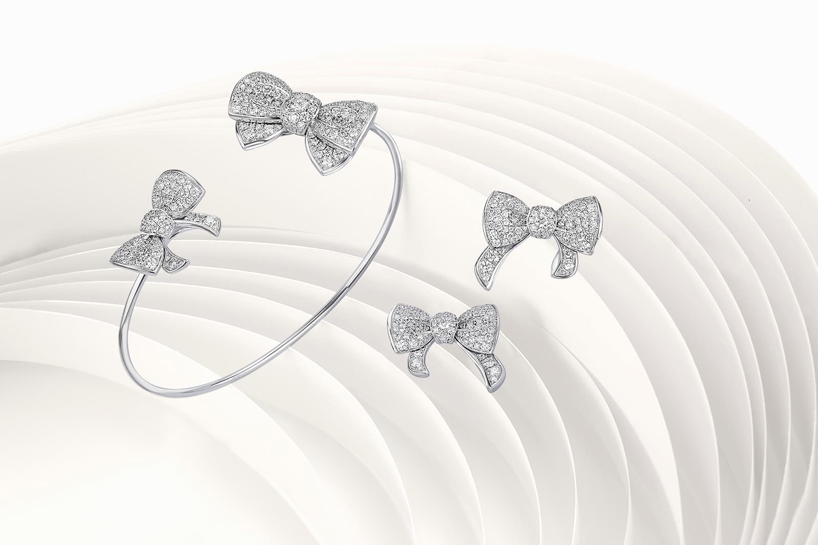 David Morris Beaux bangle and earrings with a classical bow shape in diamonds