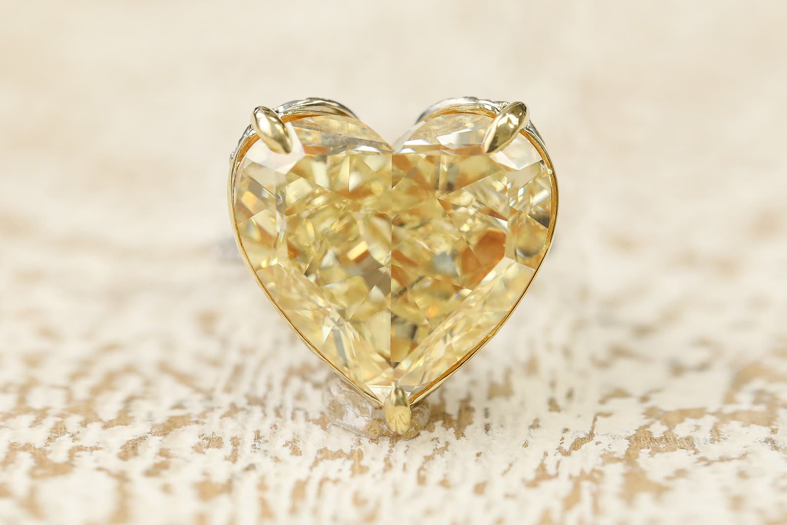 IceRock Diamonds fancy yellow heart-shaped diamond ring with a yellow gold setting (to enhance the diamond colour) and a white metal band 