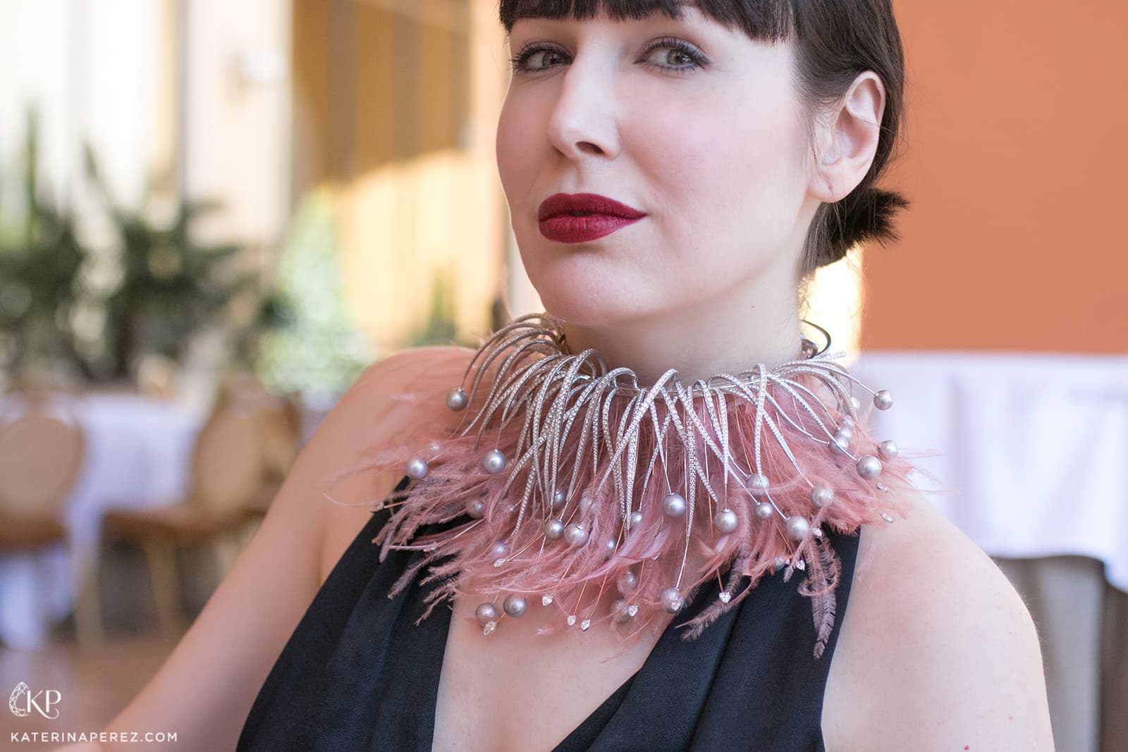 Katerina wears a feather, pearl and diamond necklace by Mike Joseph 