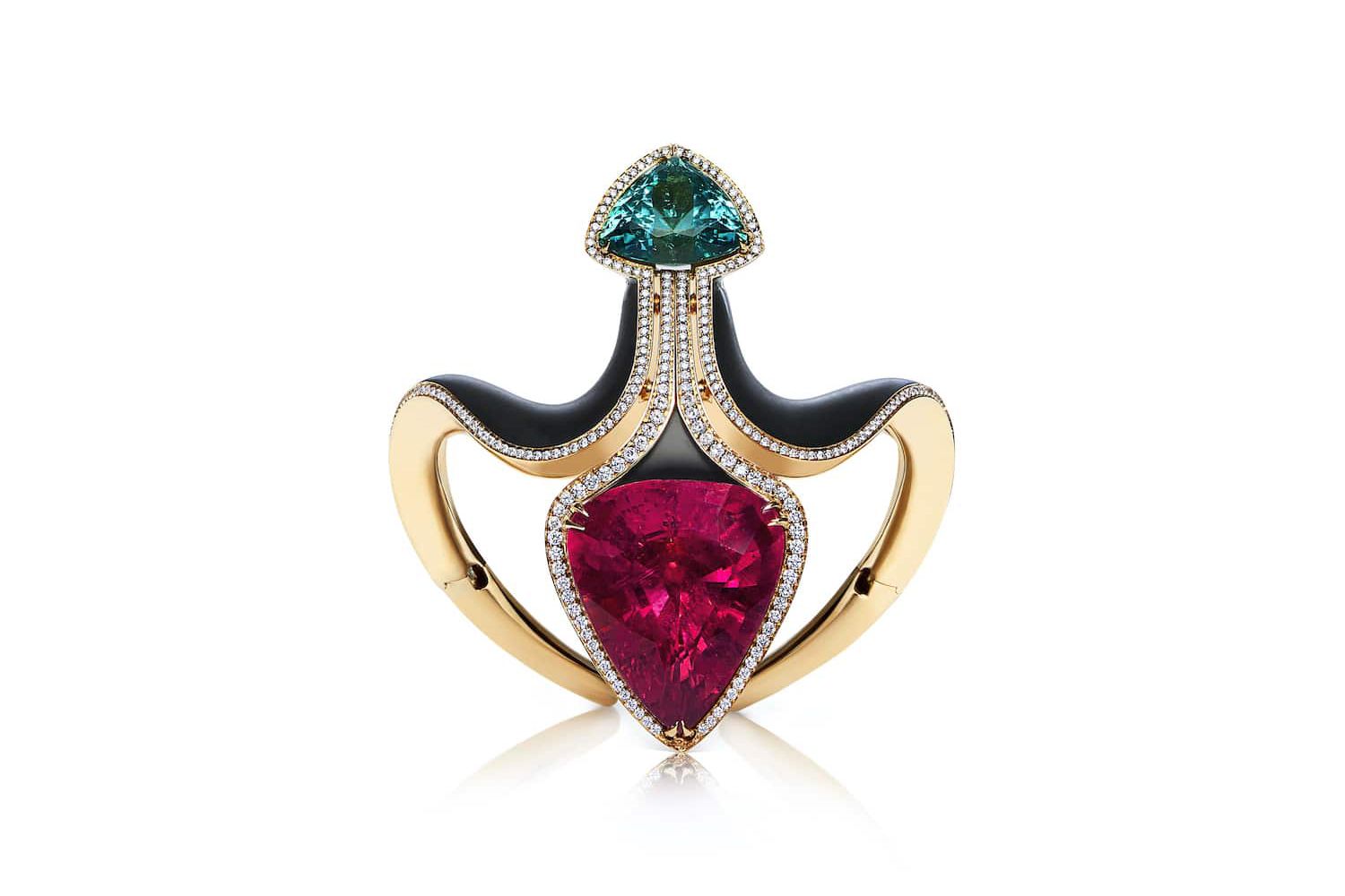  The VMAR Fleur de Lys cuff bracelet contains a large rubellite tourmaline and a green tourmaline set in ebony wood and gold
