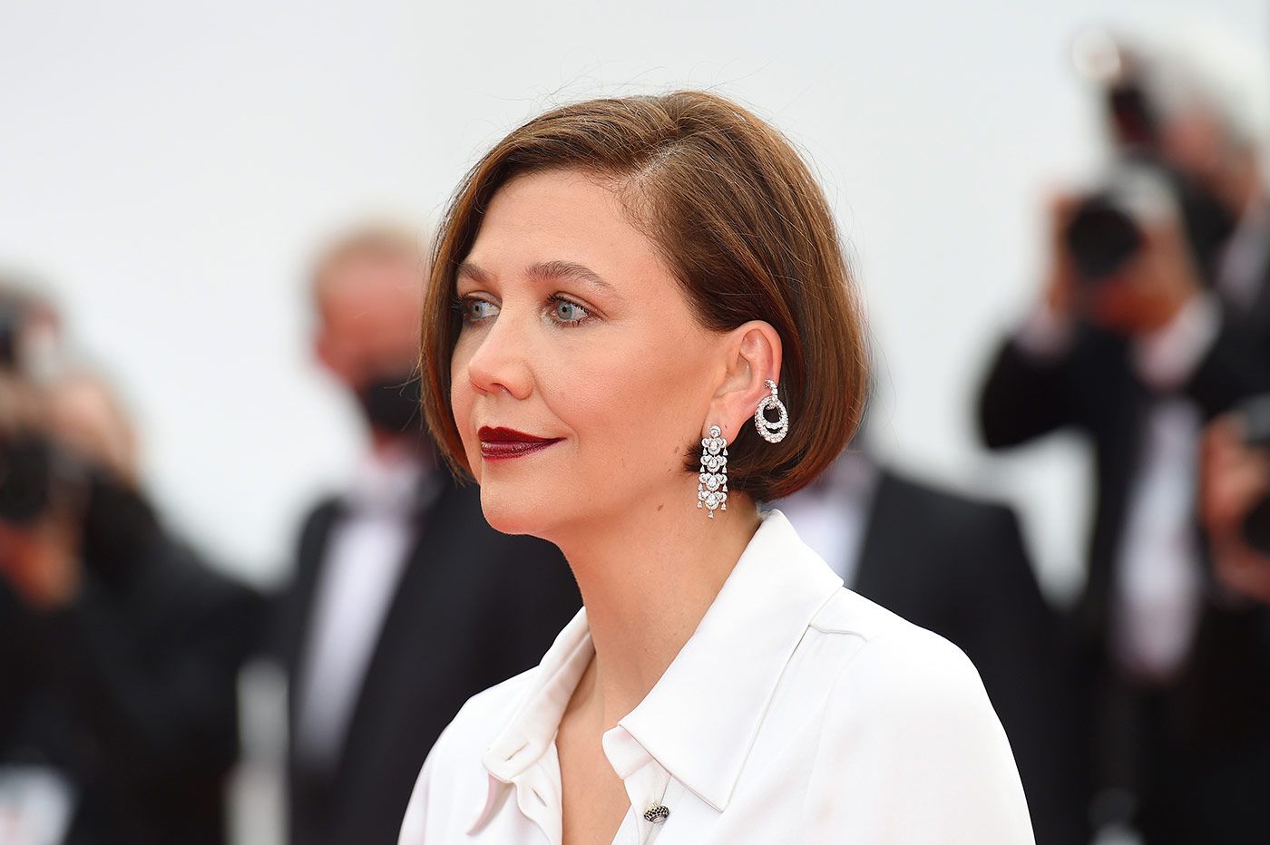 Actress Maggie Gyllenhaal layering Chopard diamond earrings at the Cannes Film Festival 2021