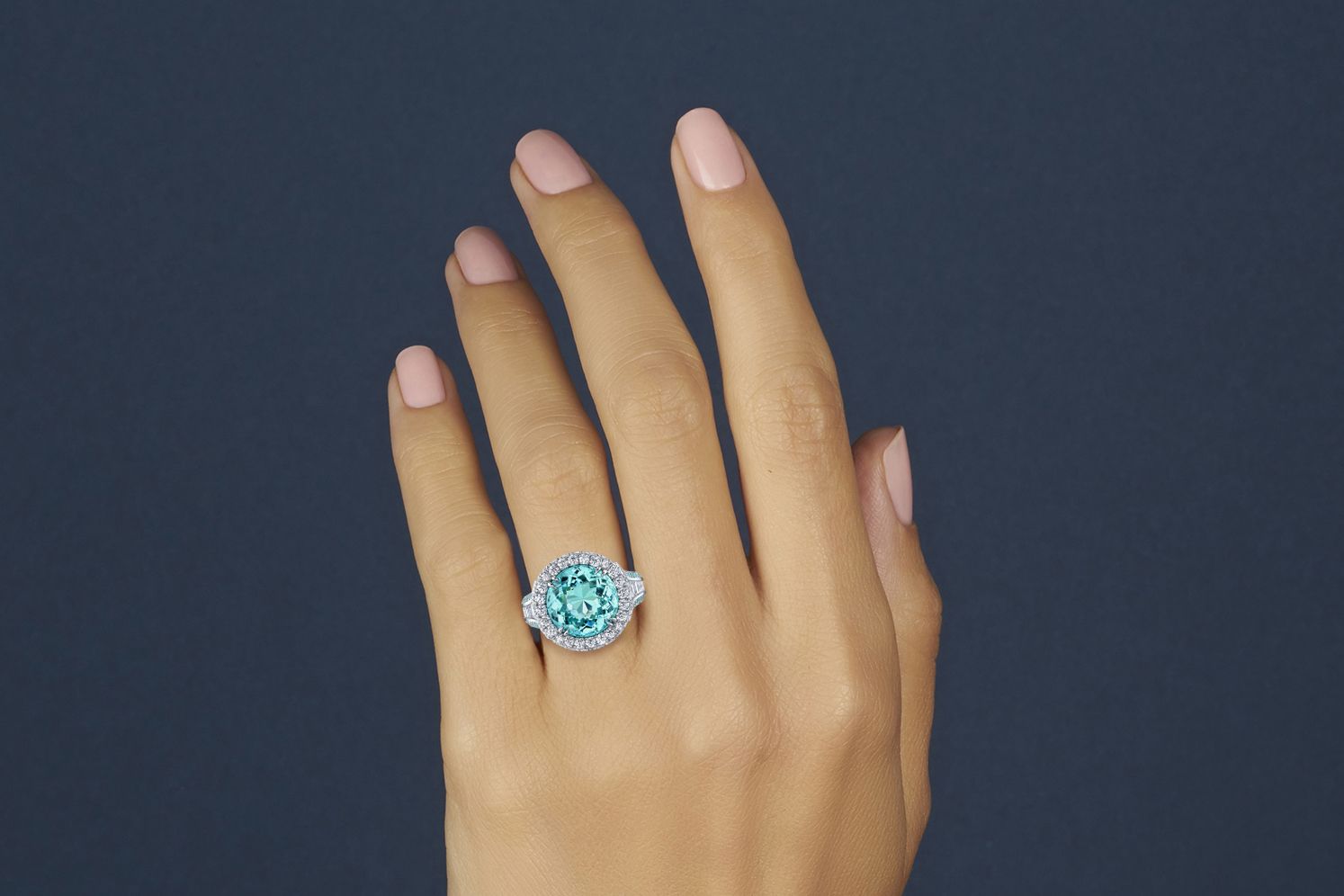  Omi Privé ring in platinum with a 7.15 carat round Paraiba-type tourmaline and diamonds