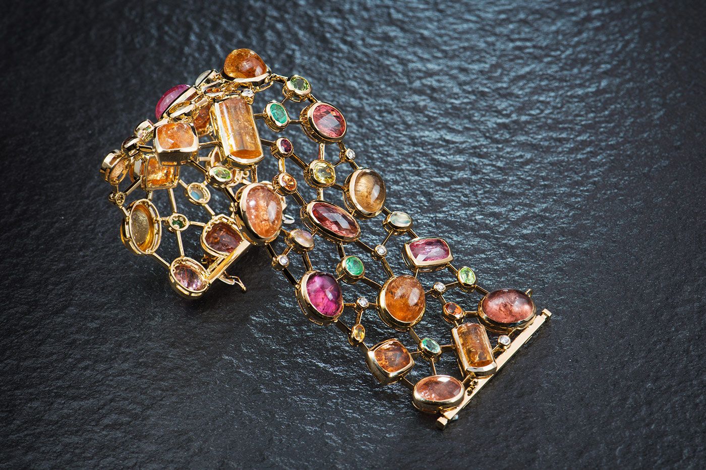 Cobweb cuff by TAYMA Fine Jewellery with Imperial topaz, Paraiba tourmalines, sapphires, moonstones, mandarin garnets and diamonds