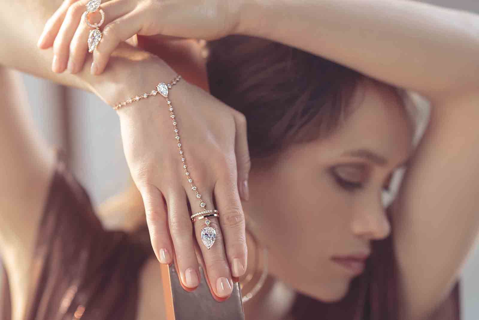 Fanny Sage wears the Dancing on Air hand bracelet with a 6.04 carat pear-shaped diamond from the Messika Magnetic Attraction High Jewellery collection