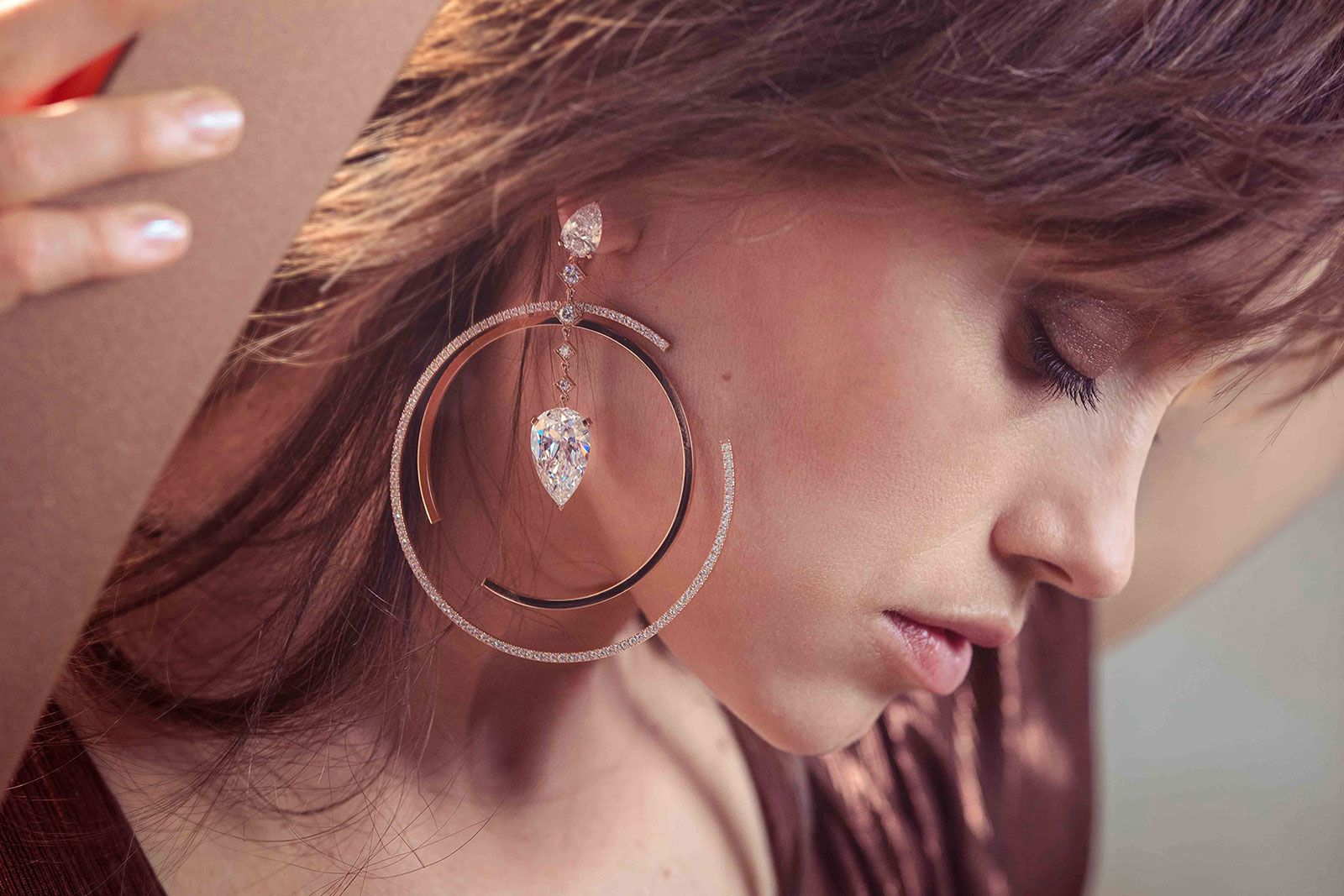 Fanny Sage wears the Dancing On Air XXL hoop earring with a 10.03 carat pear-shaped diamond from the Messika Magnetic Attraction High Jewellery collection