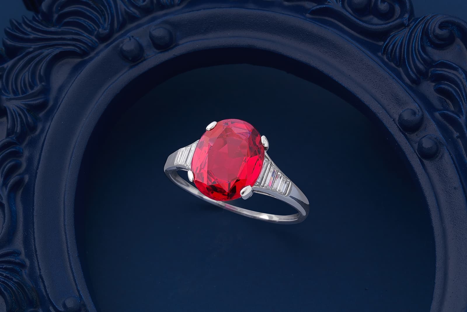  A 4.37 carat oval-cut spinel ring with tapered baguette-cut diamond shoulders, featured in the Bonhams London Jewels auction of September 2021