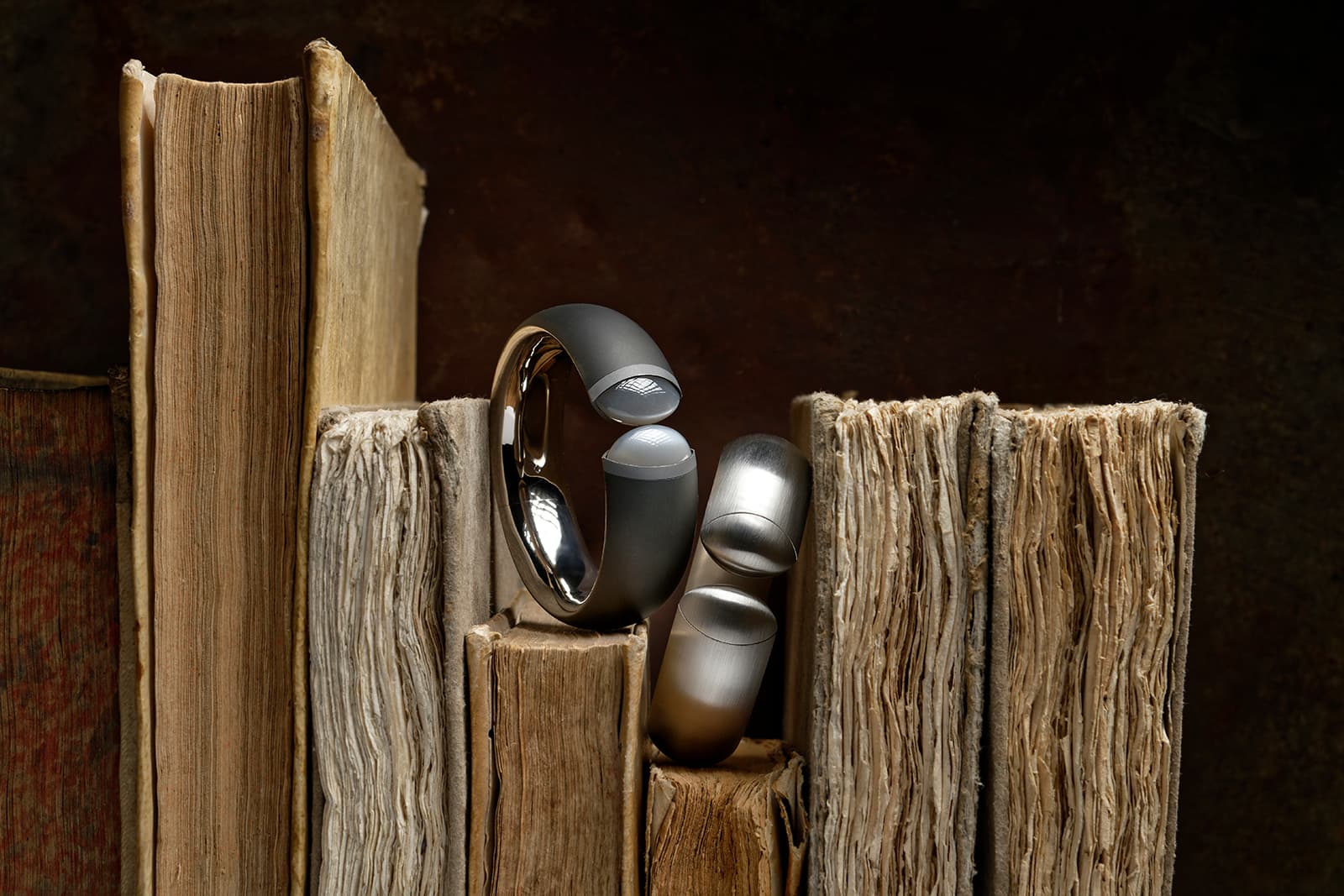 Hemmerle Harmony bangle with moonstones, iron, white gold, 1998, private collection, and a Hemmerle Harmony bangle in platinum, 1997, private collection, courtesy Hemmerle