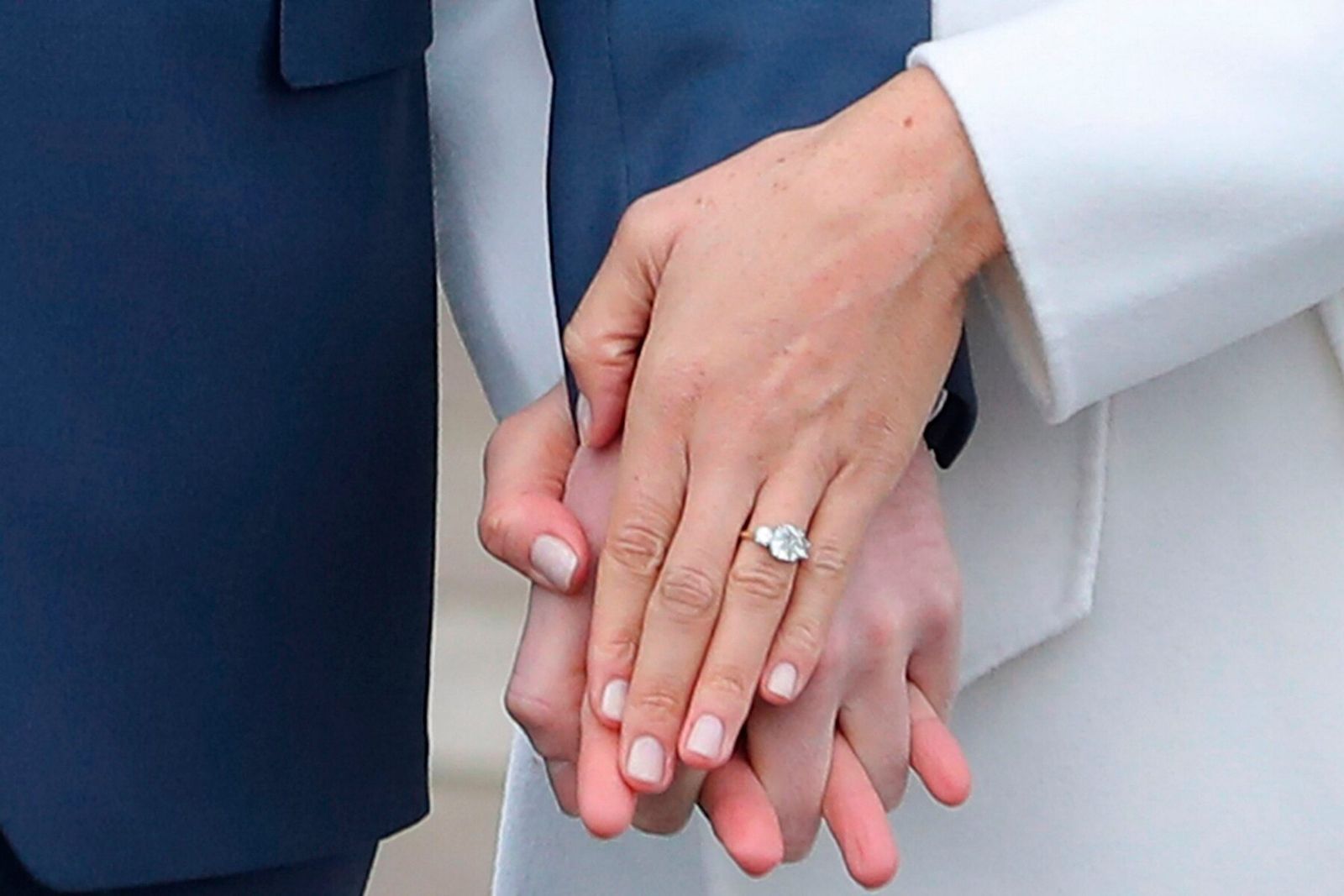 The Duchess of Sussex Meghan Markle's 6 carat cushion-cut diamond engagement ring with two round brilliant-cut diamond side stones